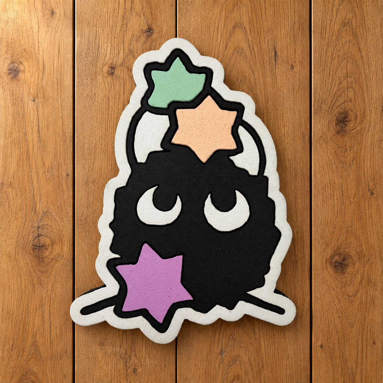 Soot sprite magnet on oak.png
