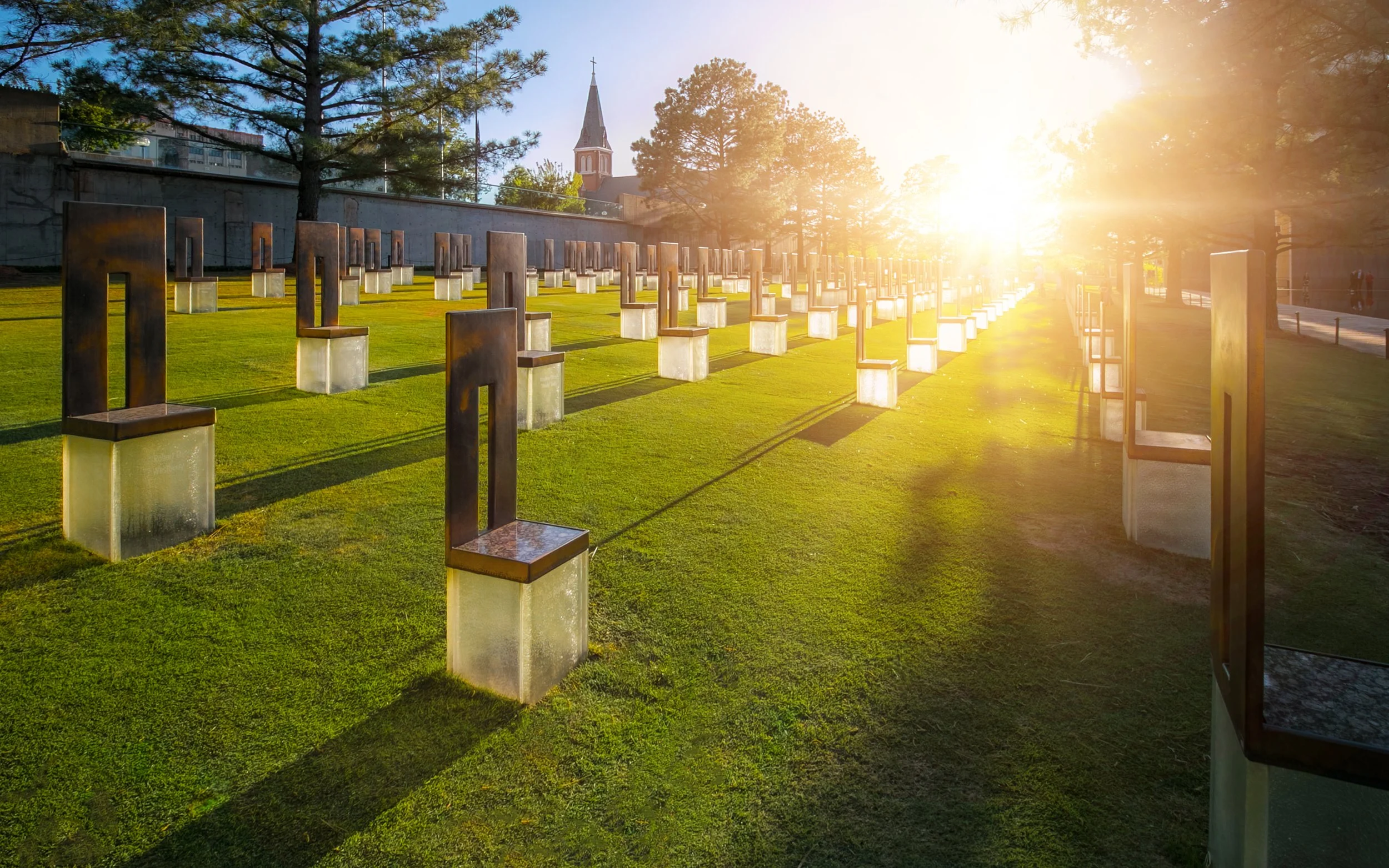 Outdoor memorial installation on a grassy field at sunset