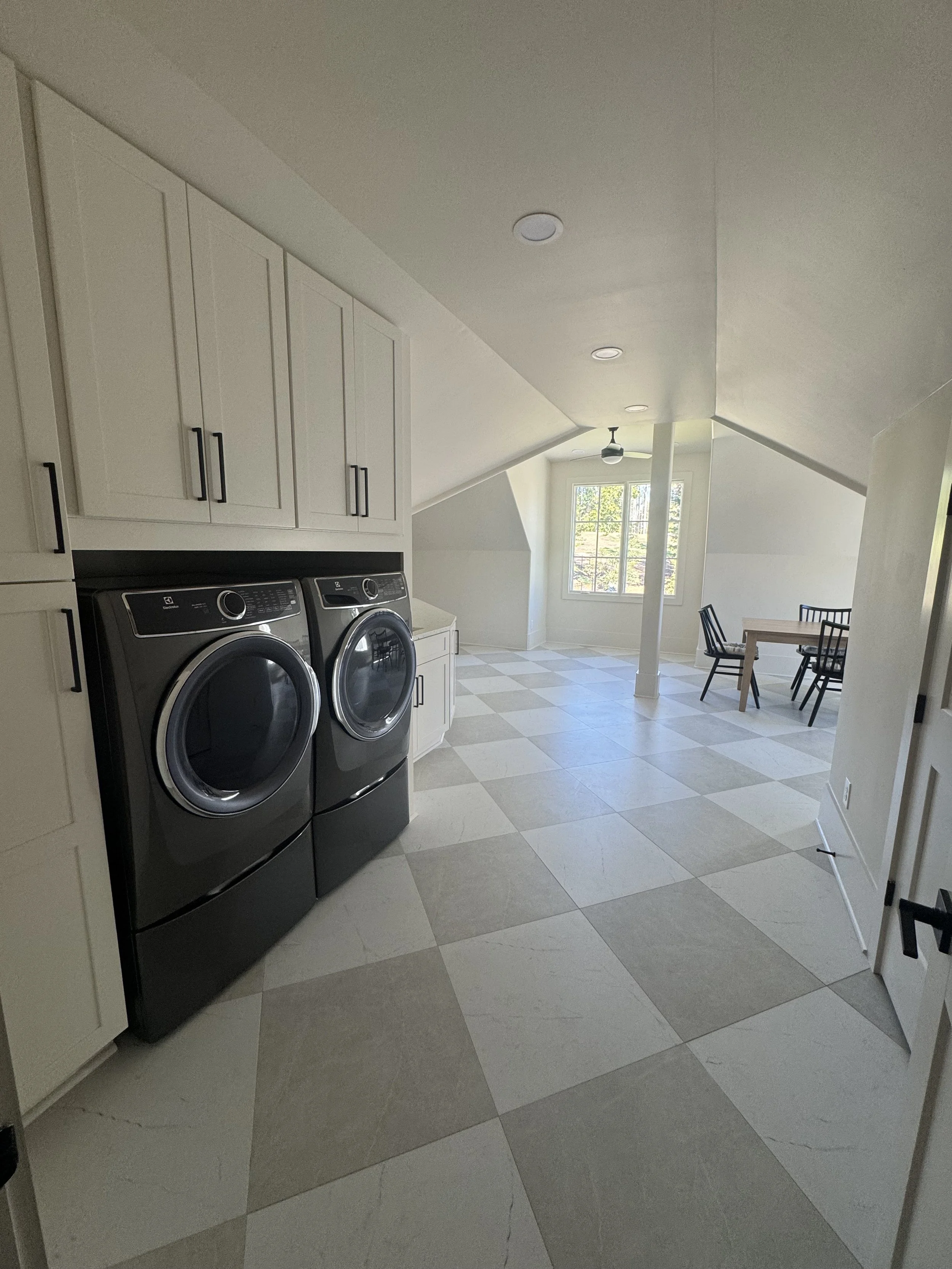 Atlanta basement finishing with new washer and dryer hookups and tasteful checkered tile