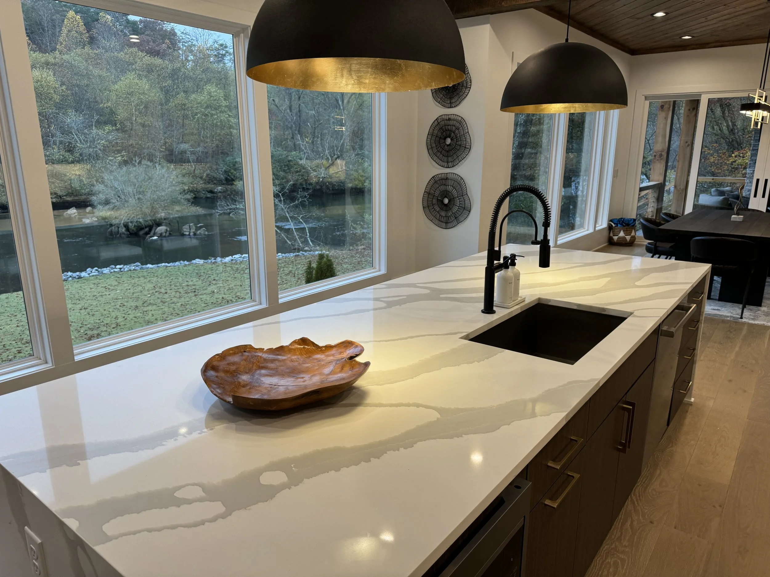 Beautiful kitchen remodel in North Atlanta, GA home featuring stylish lighting and marble countertops.