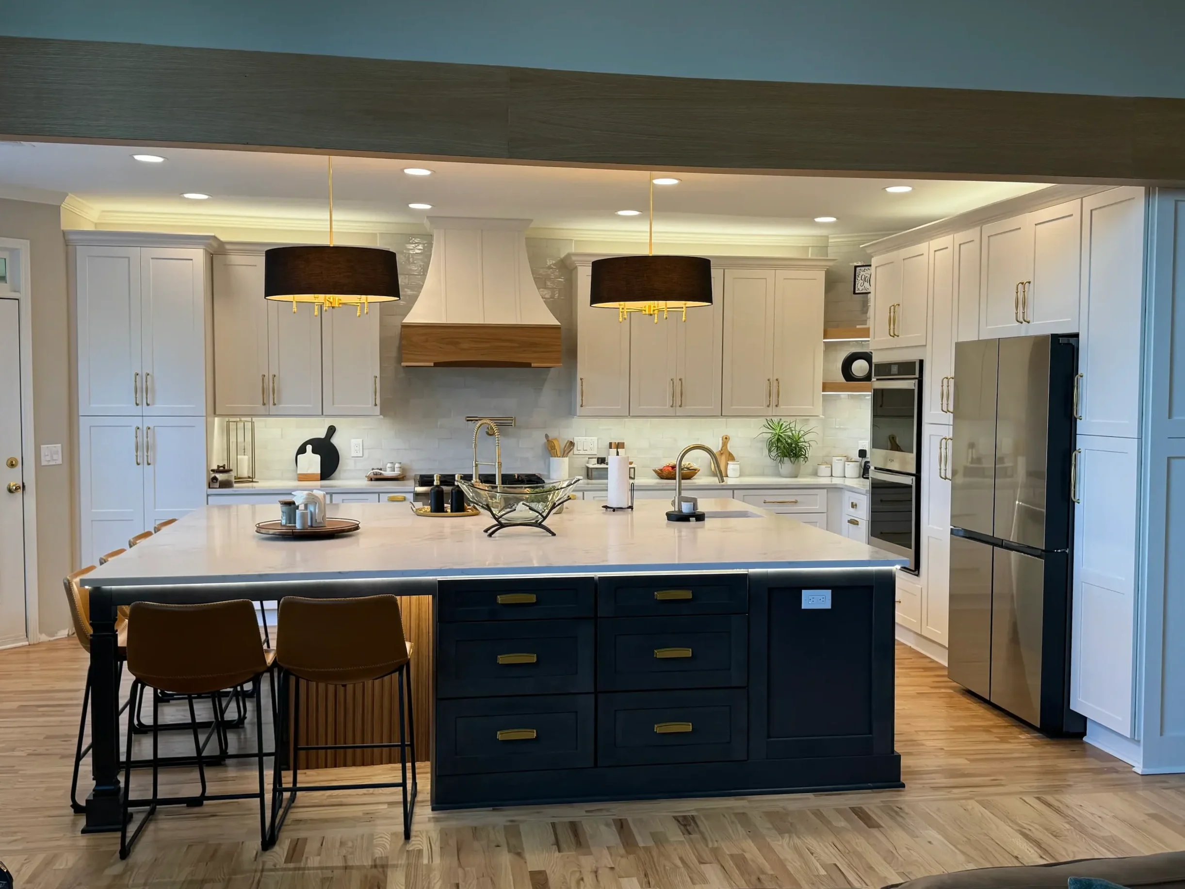 Beautiful kitchen remodel in Johns Creek, GA home featuring stylish lighting and granite countertops.