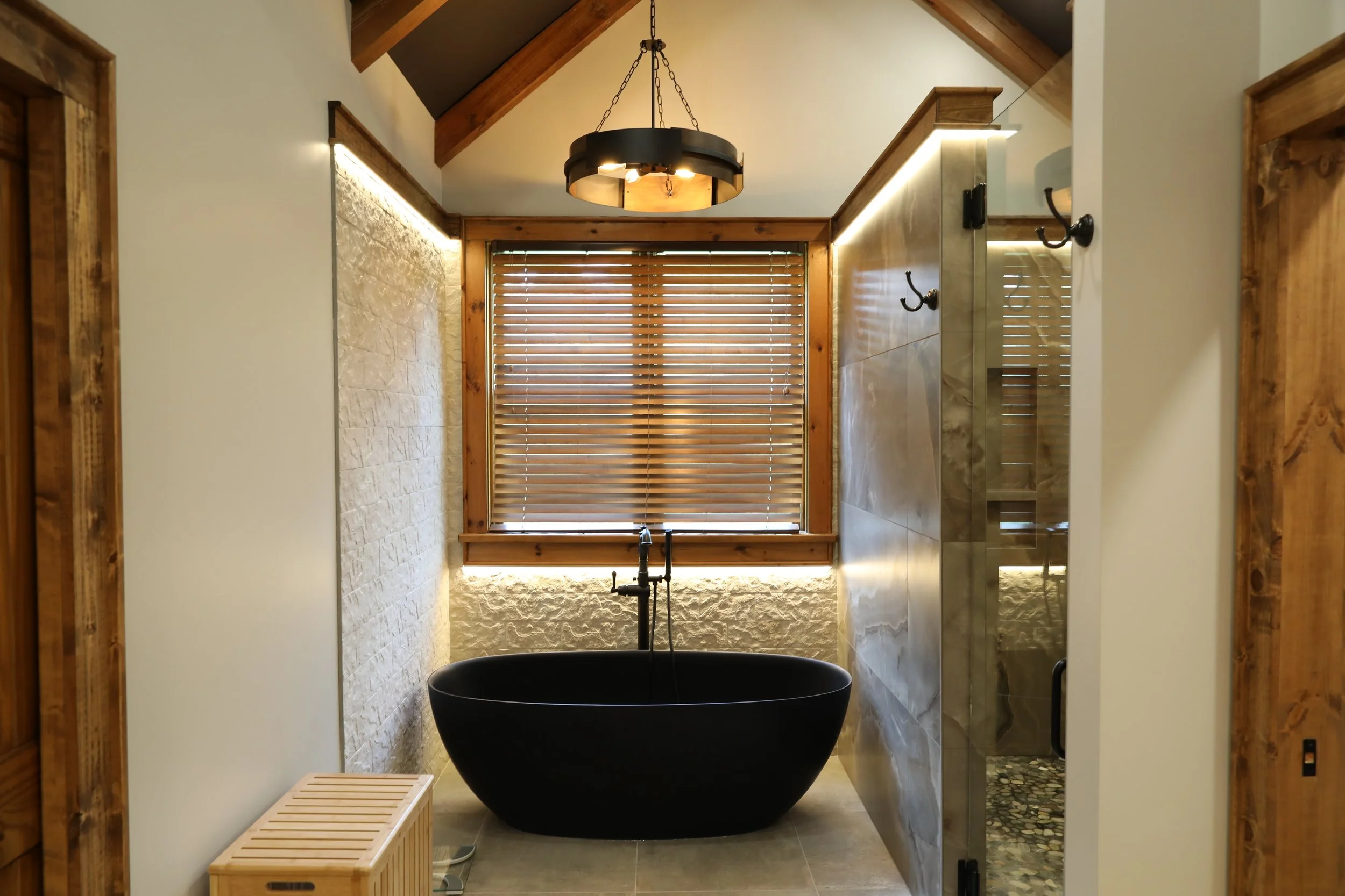 Stunning bathroom remodel in Atlanta, GA with wood and stone accents and stand alone tub