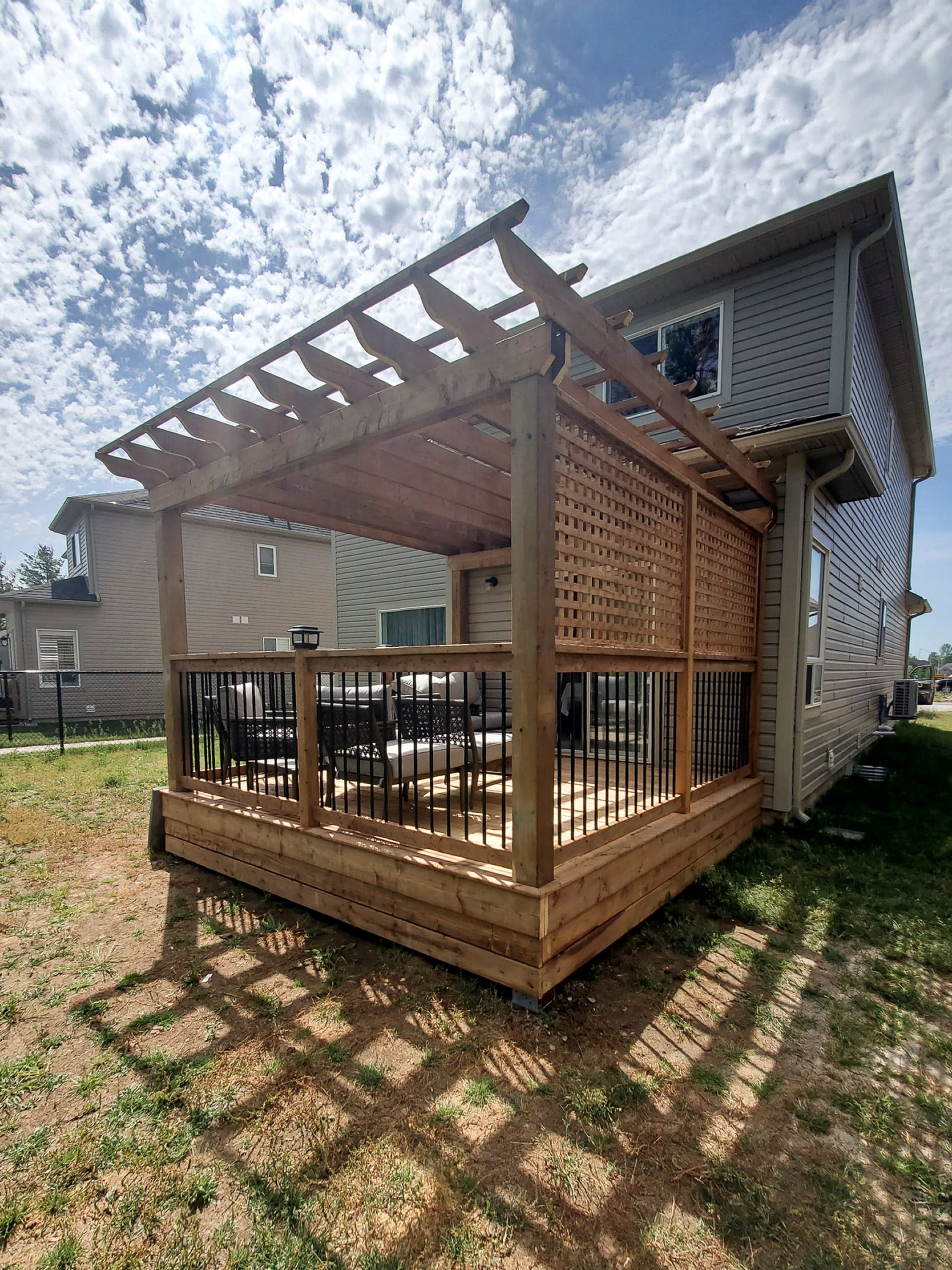 Pergola attached to deck with privacy wall panels