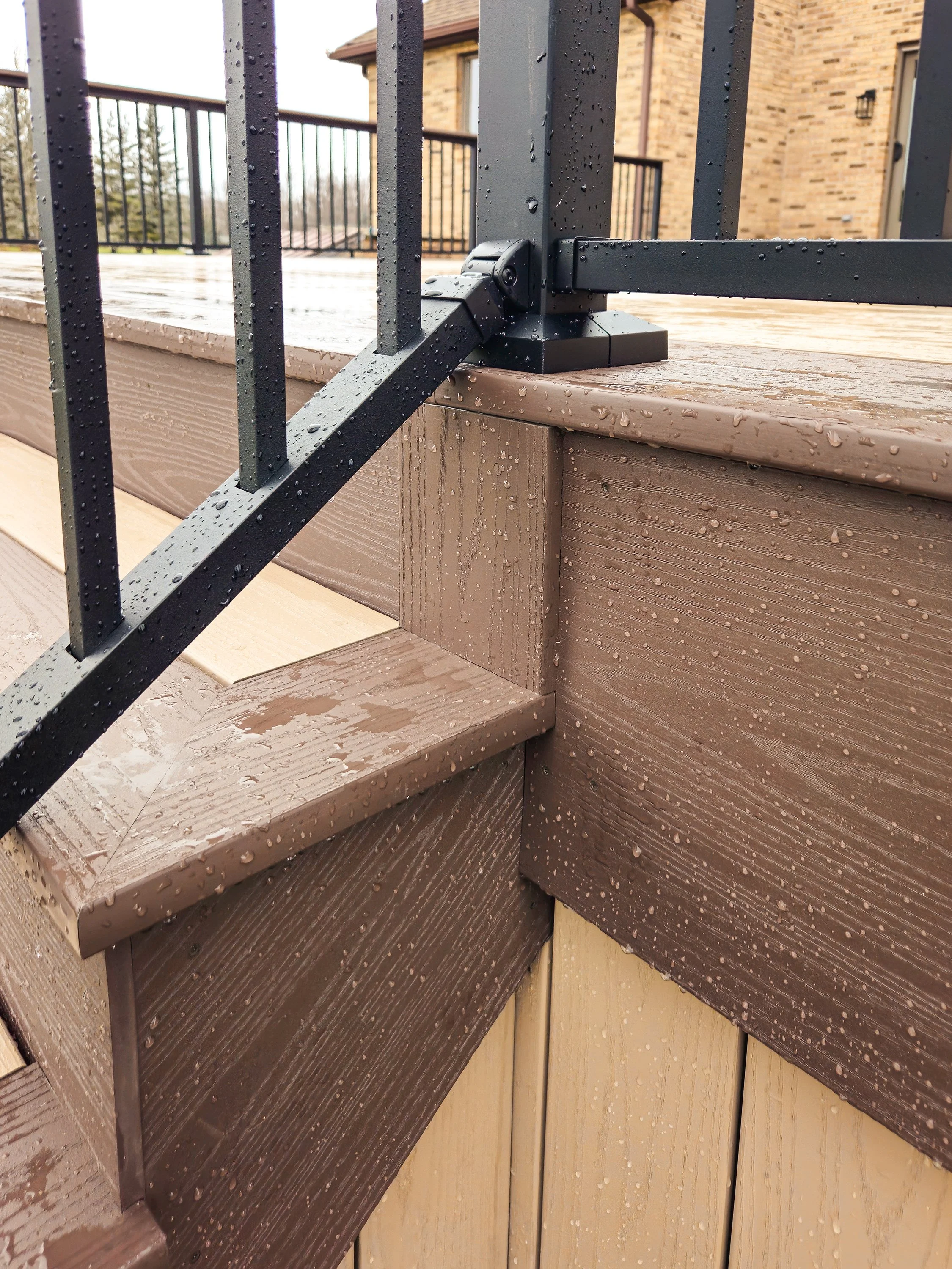 Railing post connection detail on PVC deck with Brownstone trim.