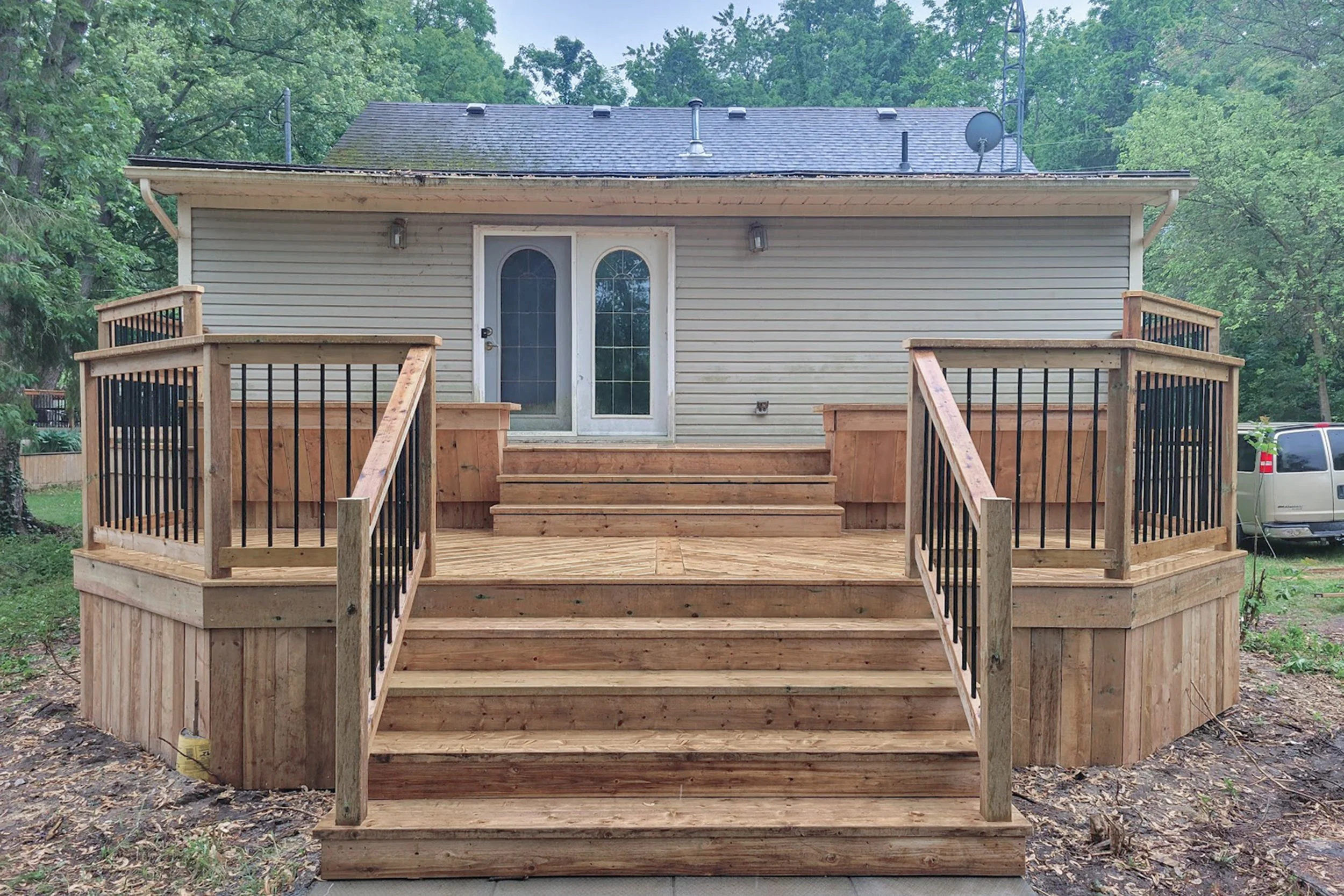 Wood deck with central staircase and two built-in side benches.