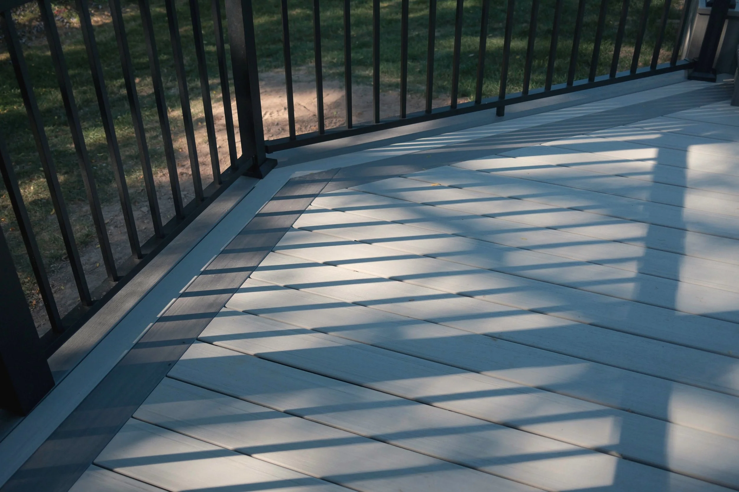 PVC deck board pattern detail with black railing.