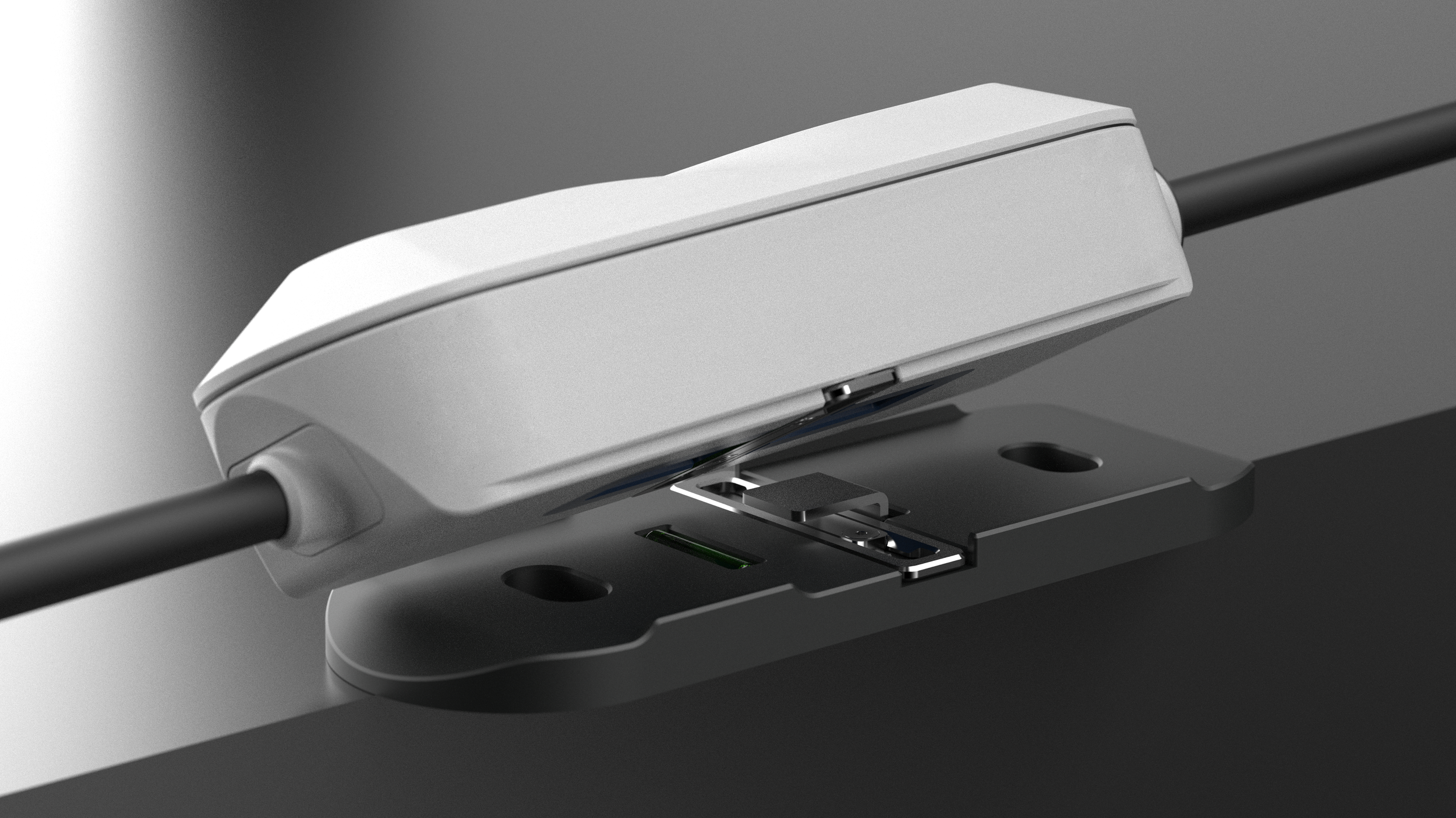 Close-up of a computer trackpad with a white external device connected to it.