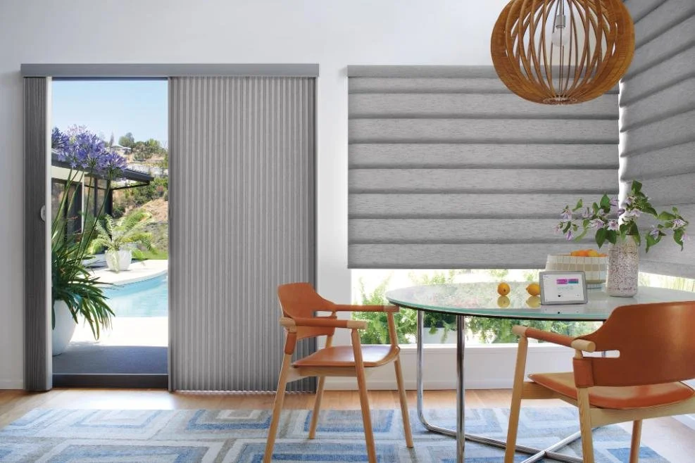 Modern dining area with motorized roller shades and vertical blinds providing sleek light control, featuring custom window blinds, shades, and shutters Penfield, NY for contemporary style and functionality.