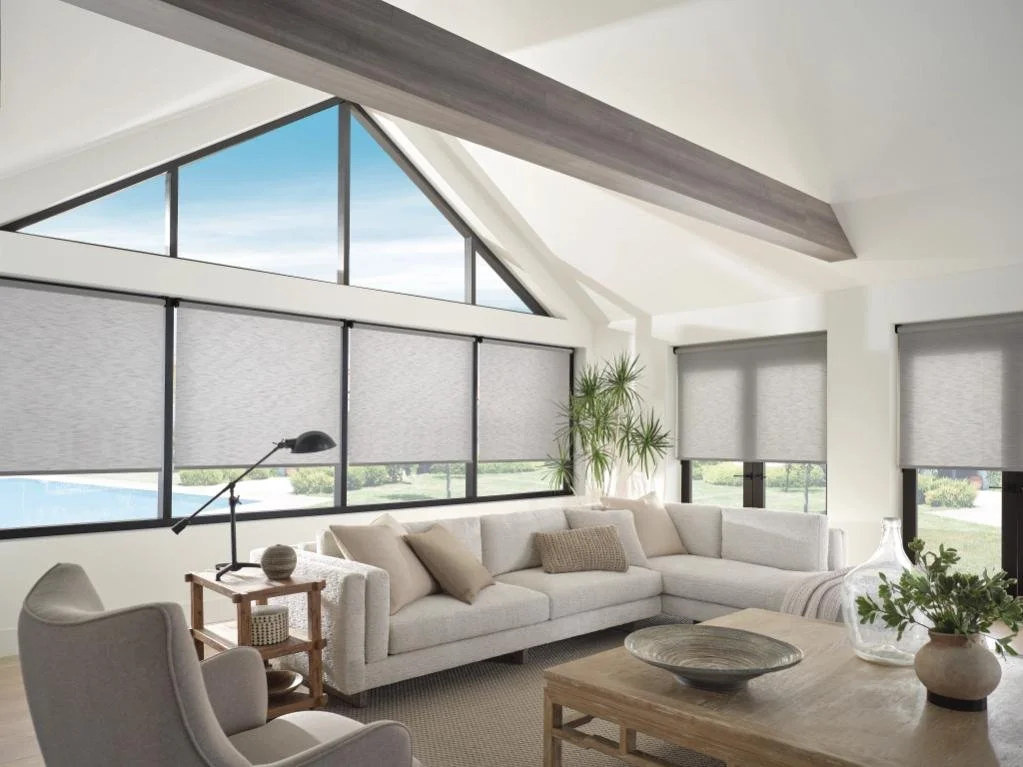 Contemporary living room with large windows and modern roller shades providing light control, featuring custom window blinds, shades, and shutters Penfield, NY for a clean, tailored look.