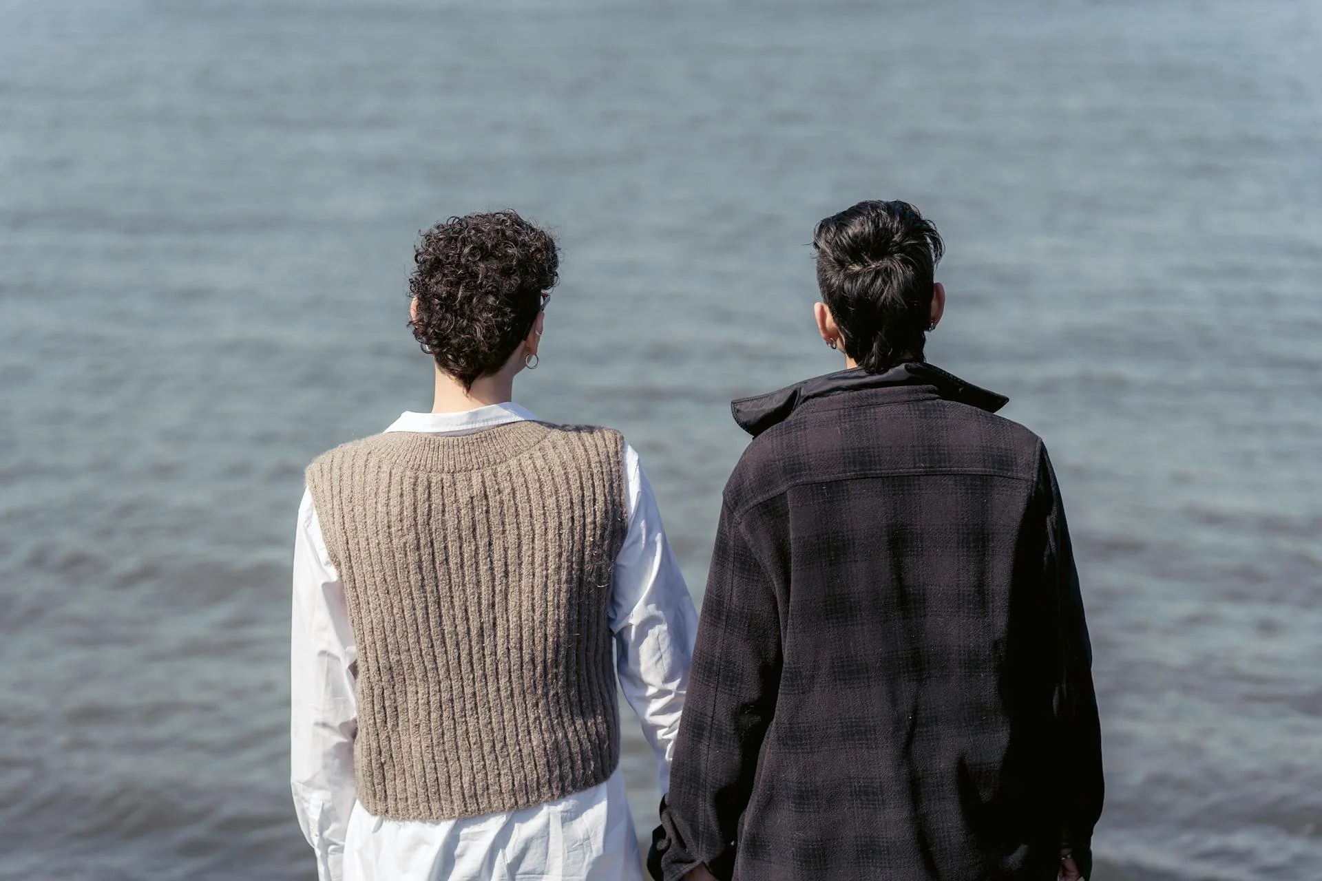 Couple standing together holding hands and reflecting after infidelity in their relationship