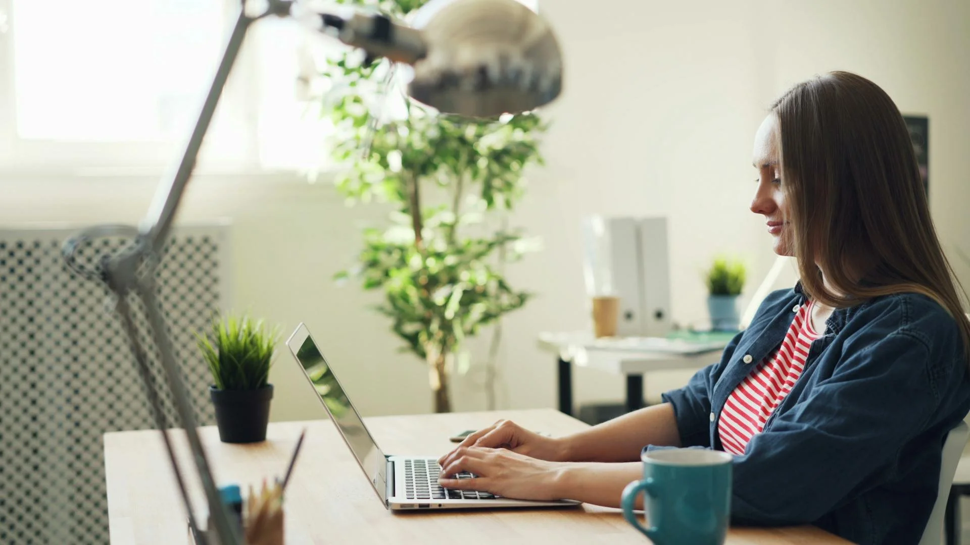 Woman working in a calm home office with natural light to support focus and concentration