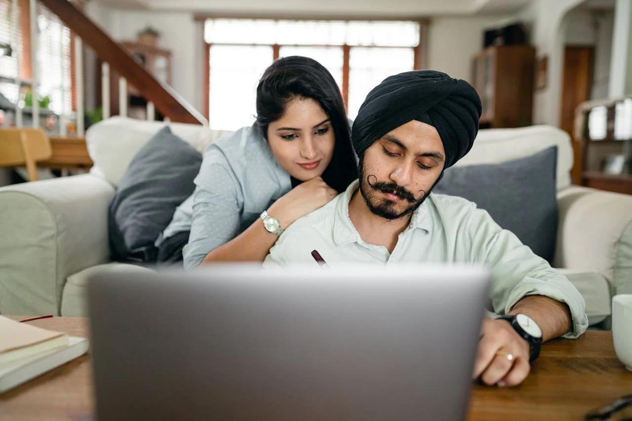 Couple participating in an online couples counselling session together from home in Alberta.