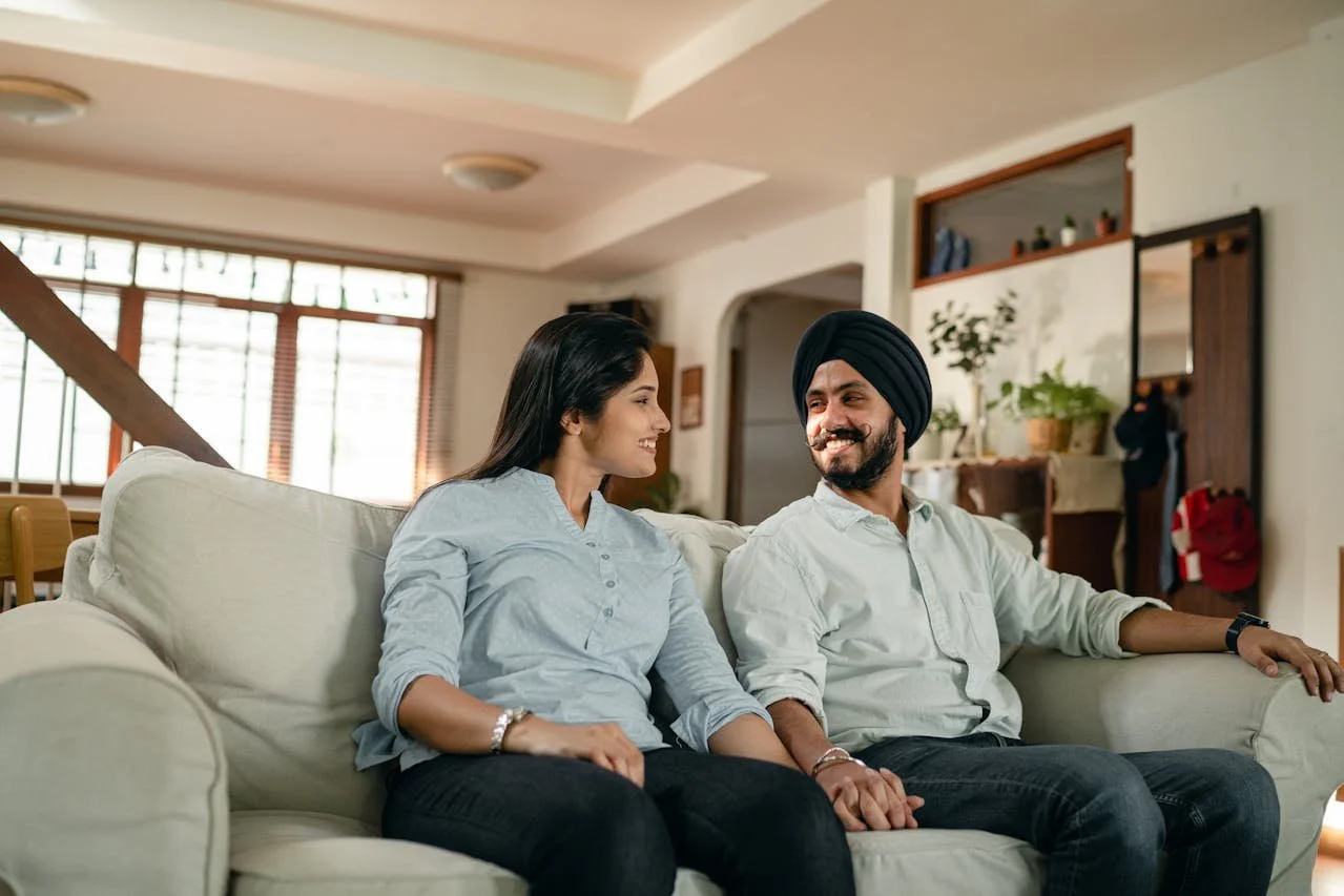 Couple sitting together and reconnecting after participating in couples counselling in Alberta.