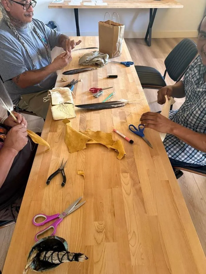 Craft workshop table with leather and feathers