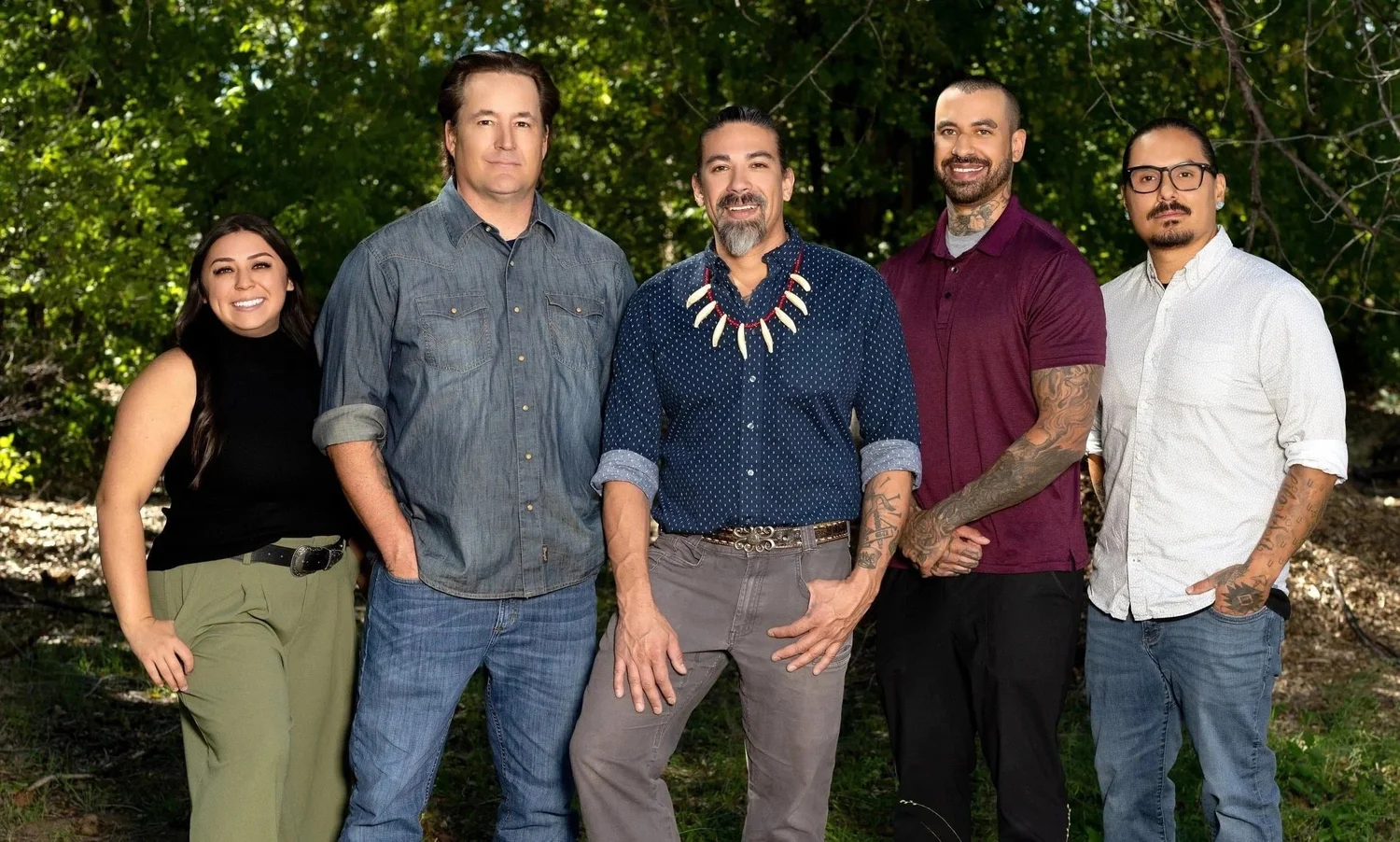 Five members of the Thundermaker Wellness Center team standing together outdoors among the trees