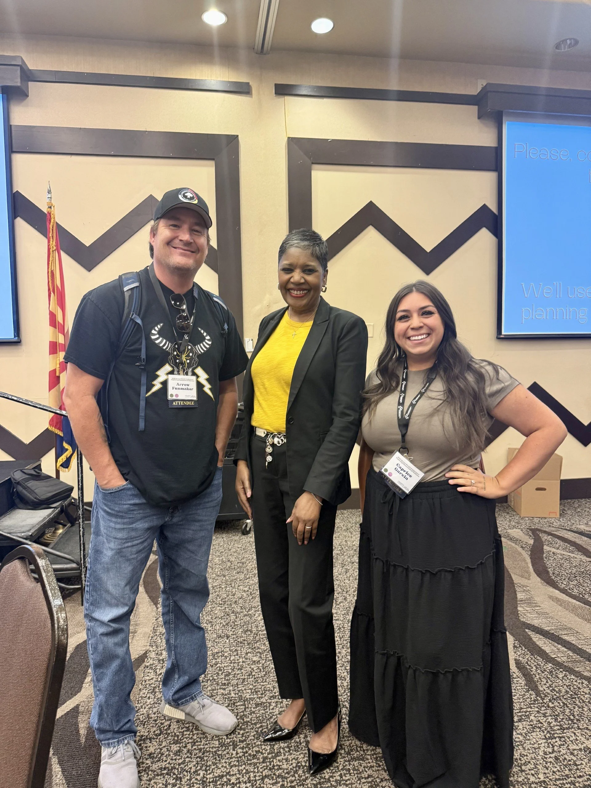The founder of Thundermaker Wellness standing next to two woman at the Yavapai Mental Health Conference in 2025, talking to Dr.  Dwinita Mosby Tyler in Prescott Arizona at the Prescott Resort and Casino.