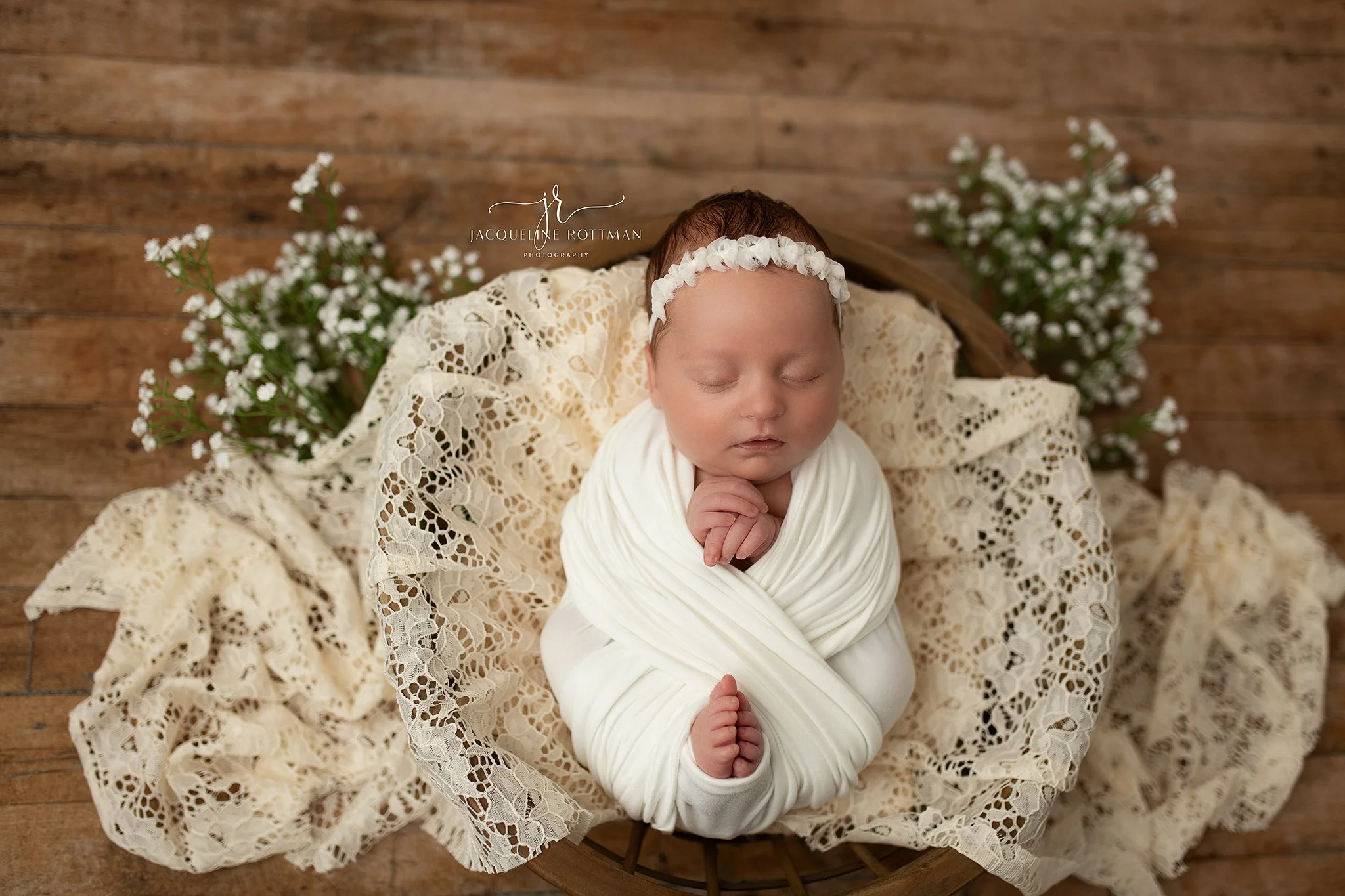 Newborn baby posed in wooden bowl prop with soft neutral tones professional studio newb ornament photography Warrensburg MO
