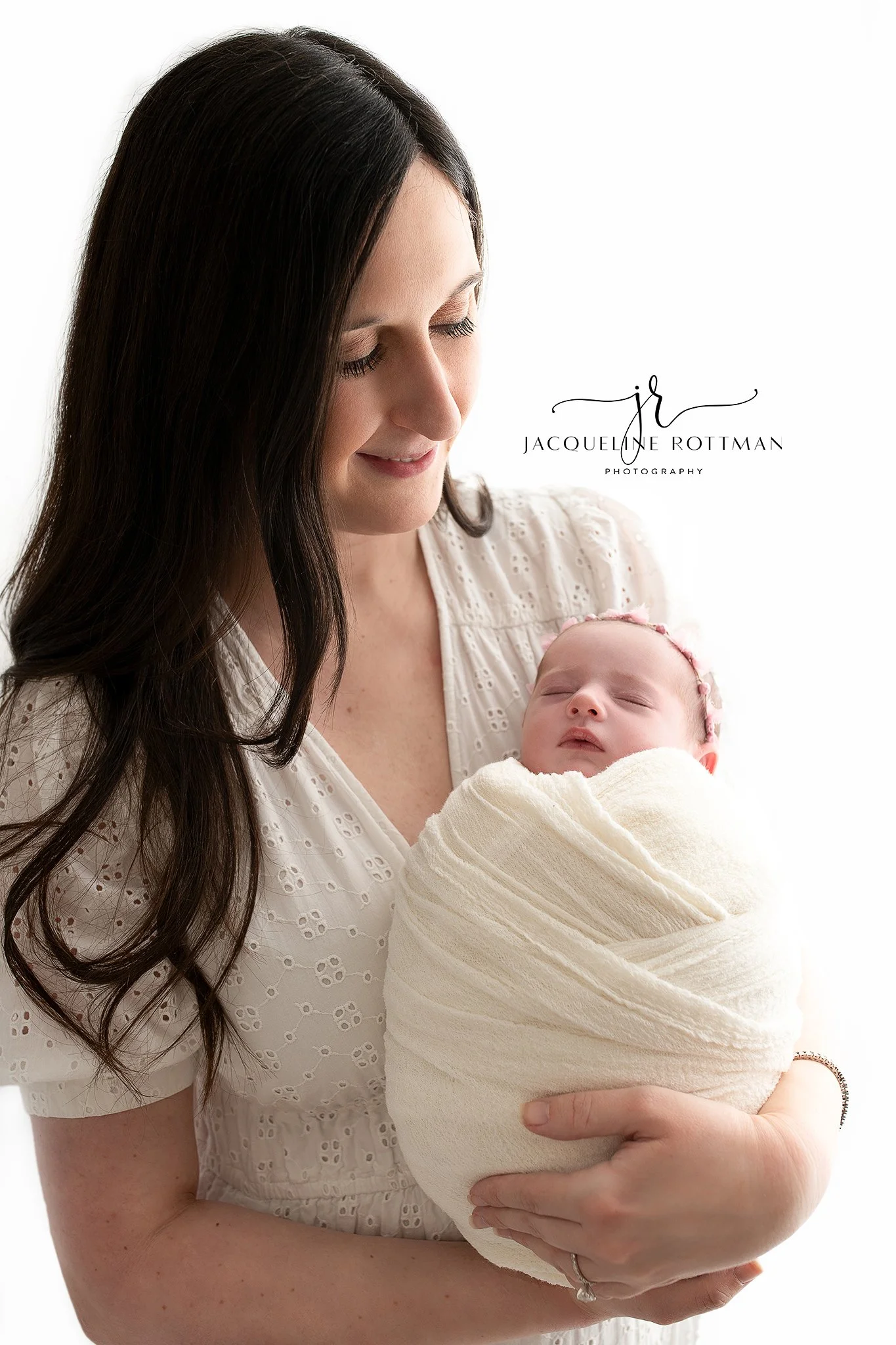mother holding her newborn during a studio newborn photography session in Iowa City, Iowa