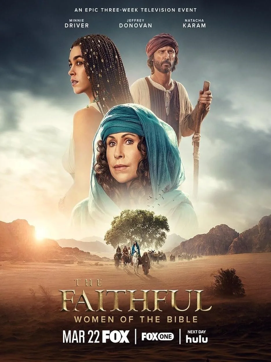 Locandina di uno spettacolo televisivo intitolato "The Faithful: Women of the Bible" con tre donne vestite in abiti storici, uno sfondo di deserto con un grande albero e una carovana di cavalli e cammelli. La locandina include i nomi Minnie Driver, Jeffrey Donovan e Natacha Karam.