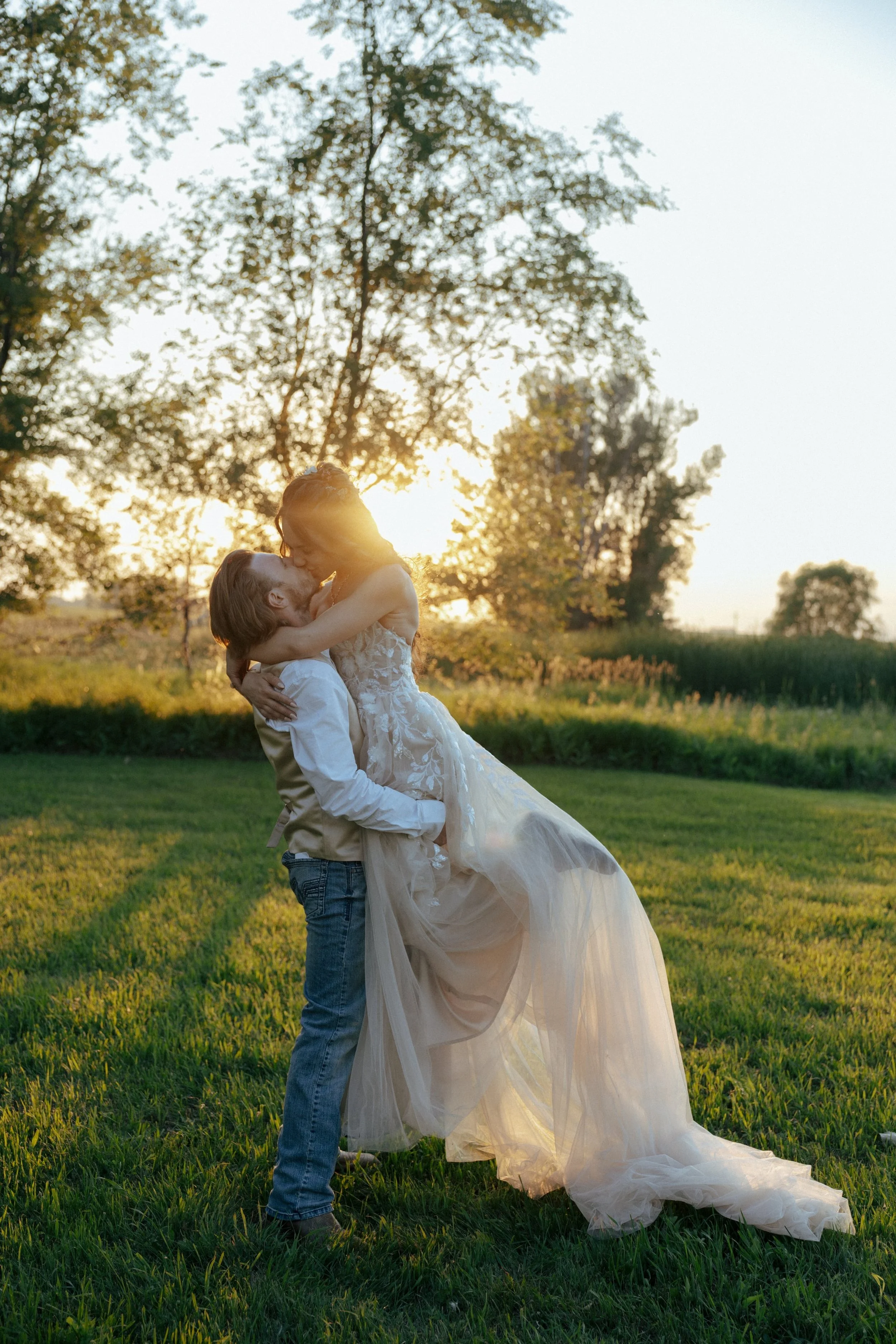 Close-up of a wedding ceremony with one person placing a ring on another's hand, while an officiant holds a paper.