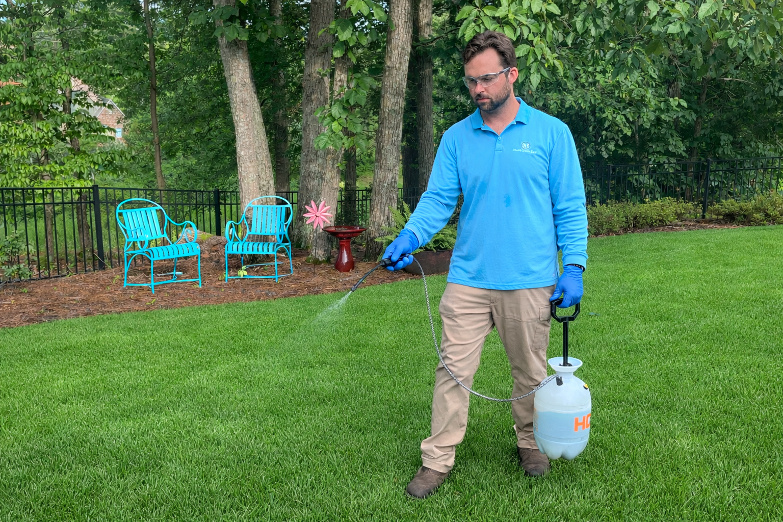 Spraying weeds with hand sprayer