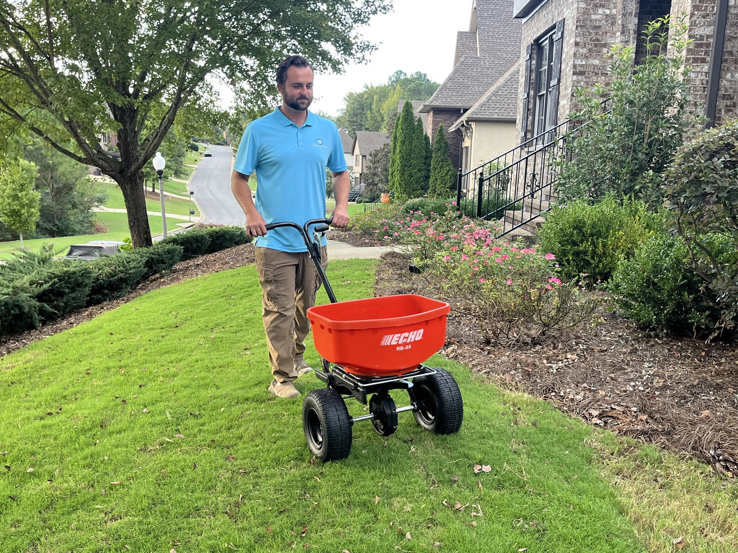 Pushing orange fertilizer spreader