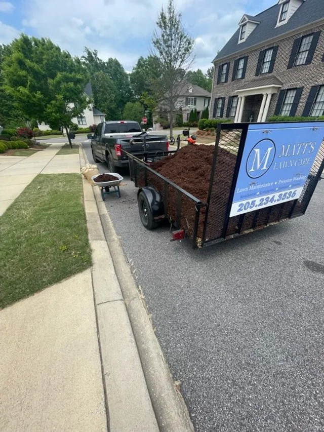 Utility trailer filled with black mulch