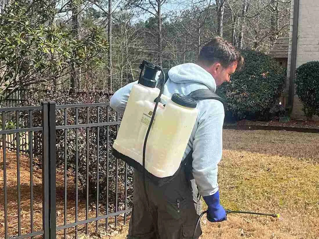 Spraying weeds with backpack sprayer