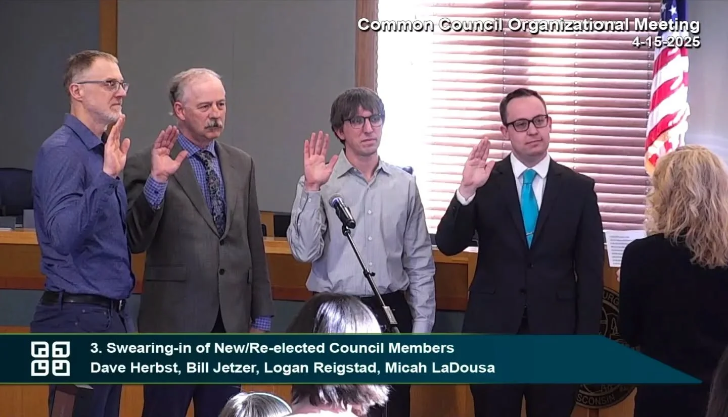 Four people raise their right hands