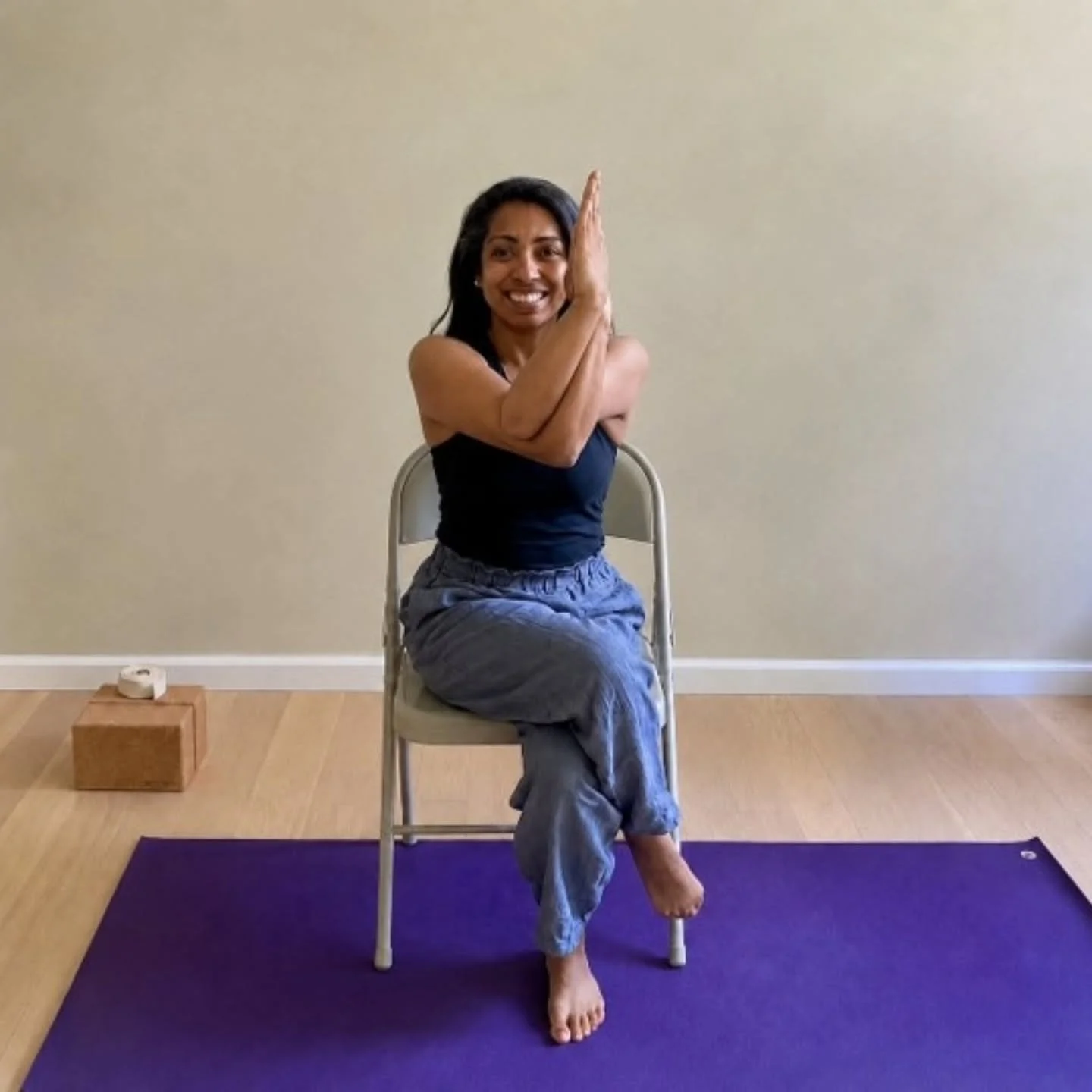 In chair Garudasana (Eagle pose), we focus on lengthening our spine, spreading our shoulder blades, bringing the elbows up to shoulder height, and squeezing our thighs together to wrap our legs.
