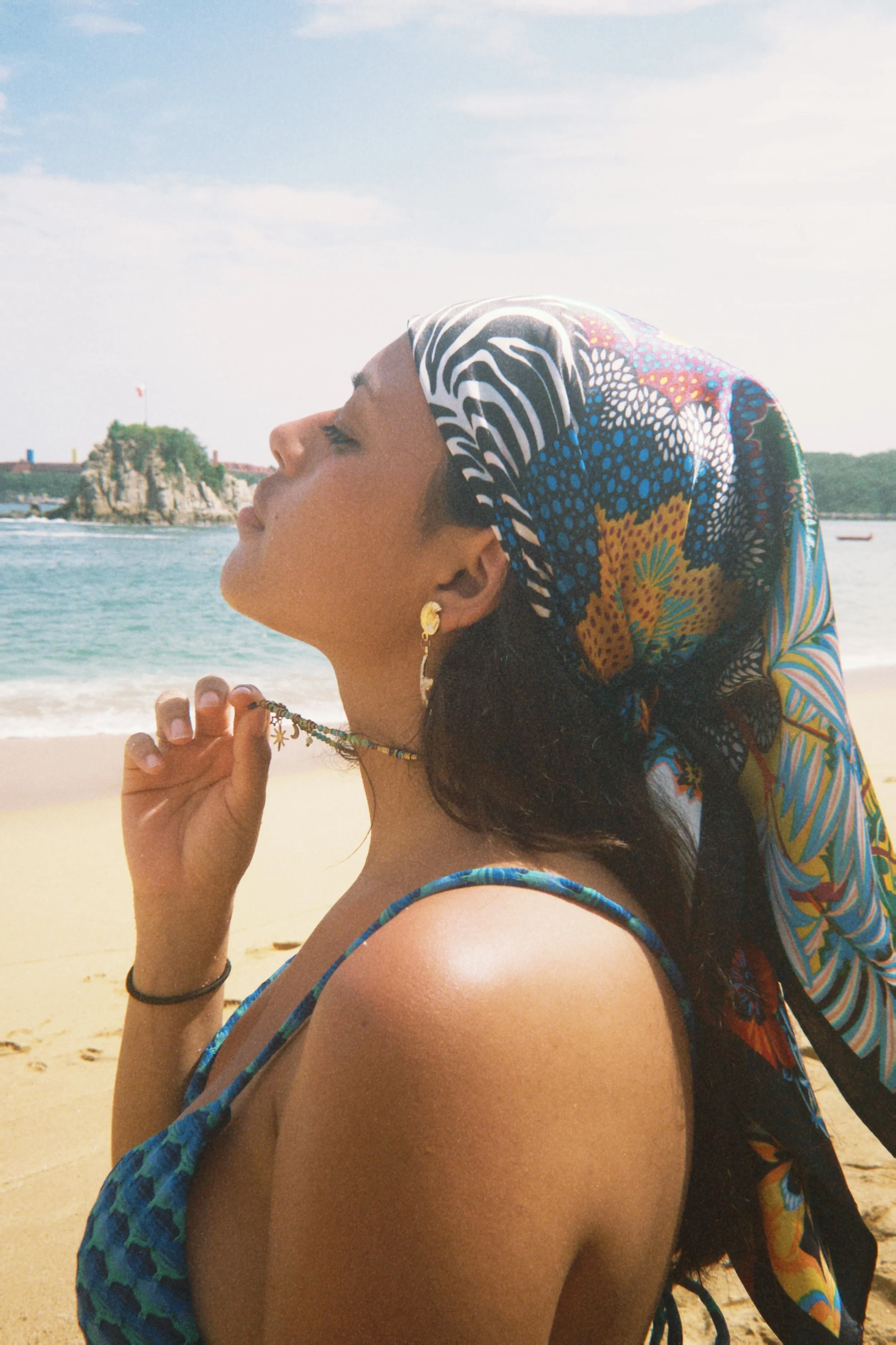 Woman in a headscarf with face to the sun representing the benefits of taking a 60 second mindfulness reset