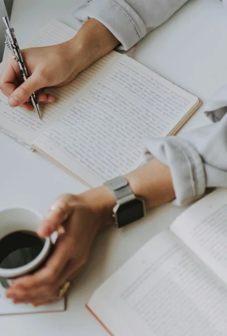 Notebook with written reflection prompts for evaluating time management progress.