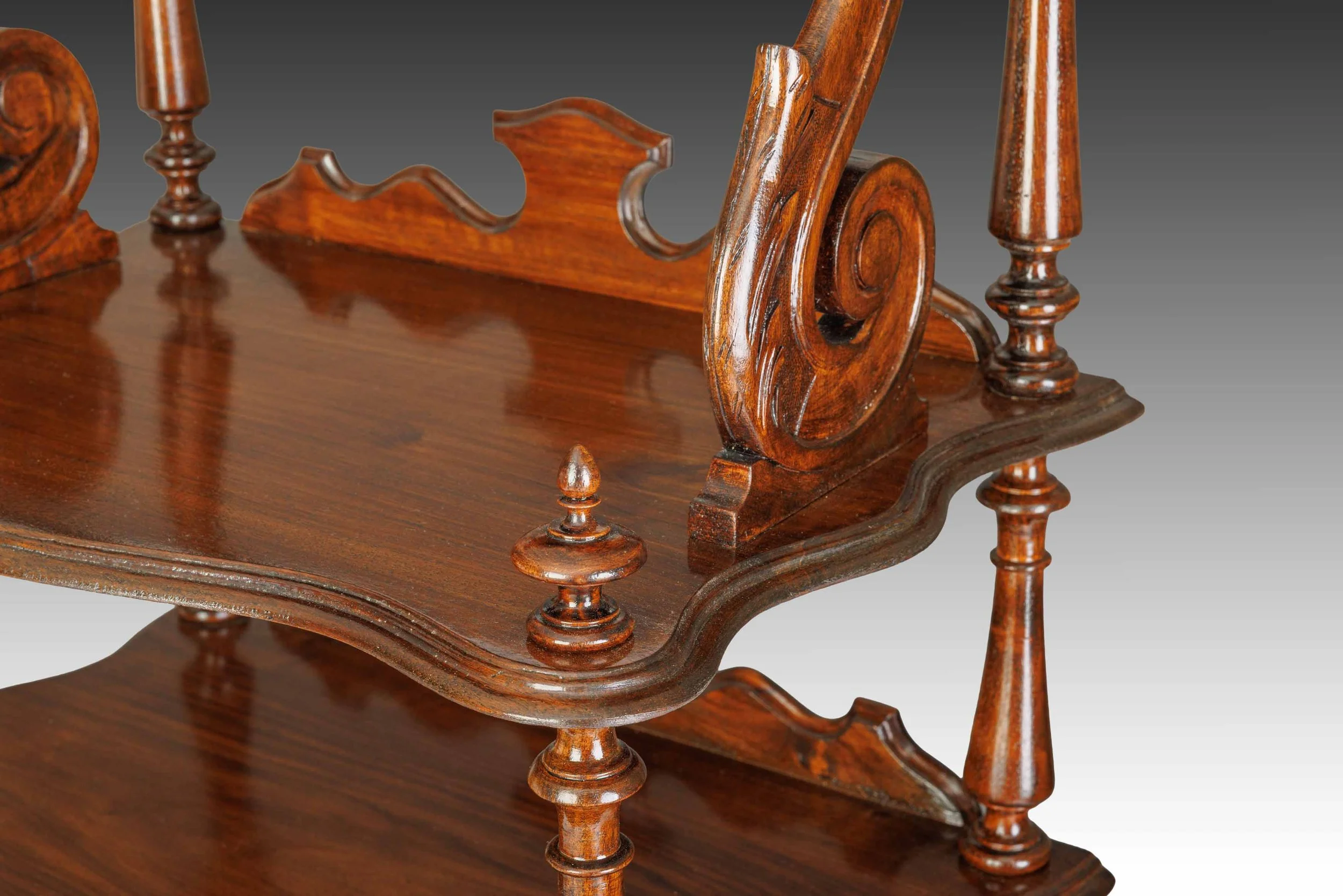 Close-up of the upper tier on The Bracknell Whatnot, featuring carved scrolled brackets and shaped gallery edging.