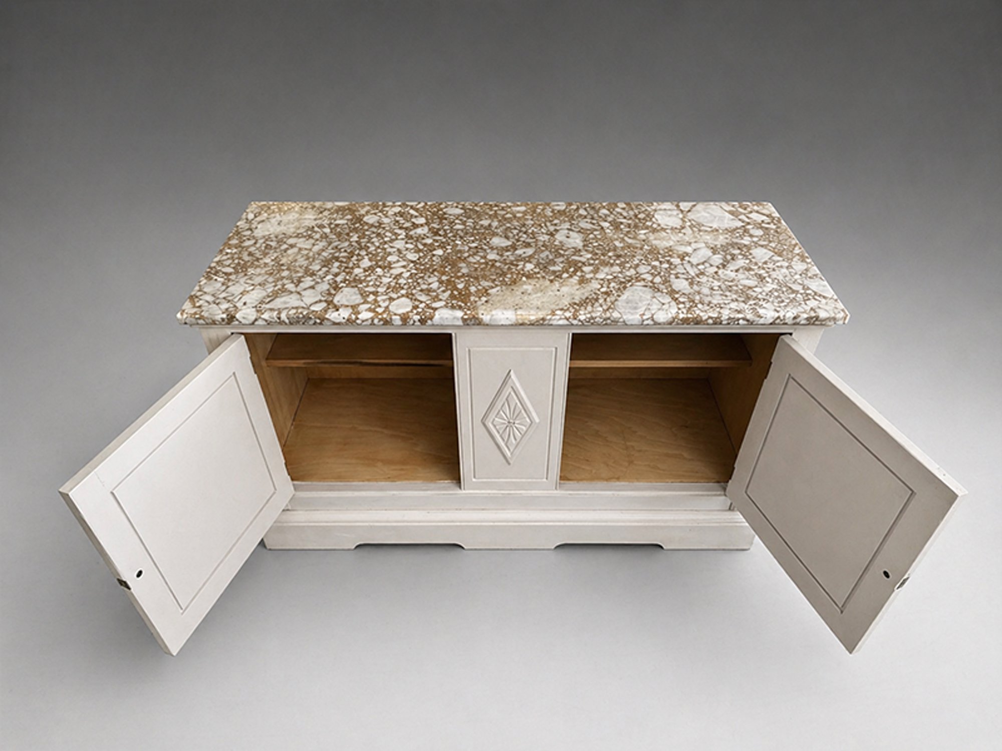 Elevated view of painted antique cabinet with stone top, open storage compartments, continuous shelf, and visible natural wood interior