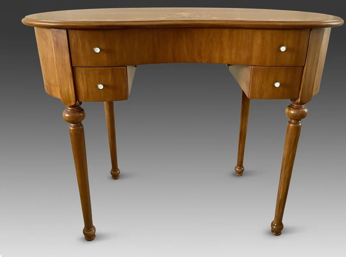 Vintage Neoclassical Revival writing desk, kidney-shaped, with marquetry top and turned legs, three-quarter view