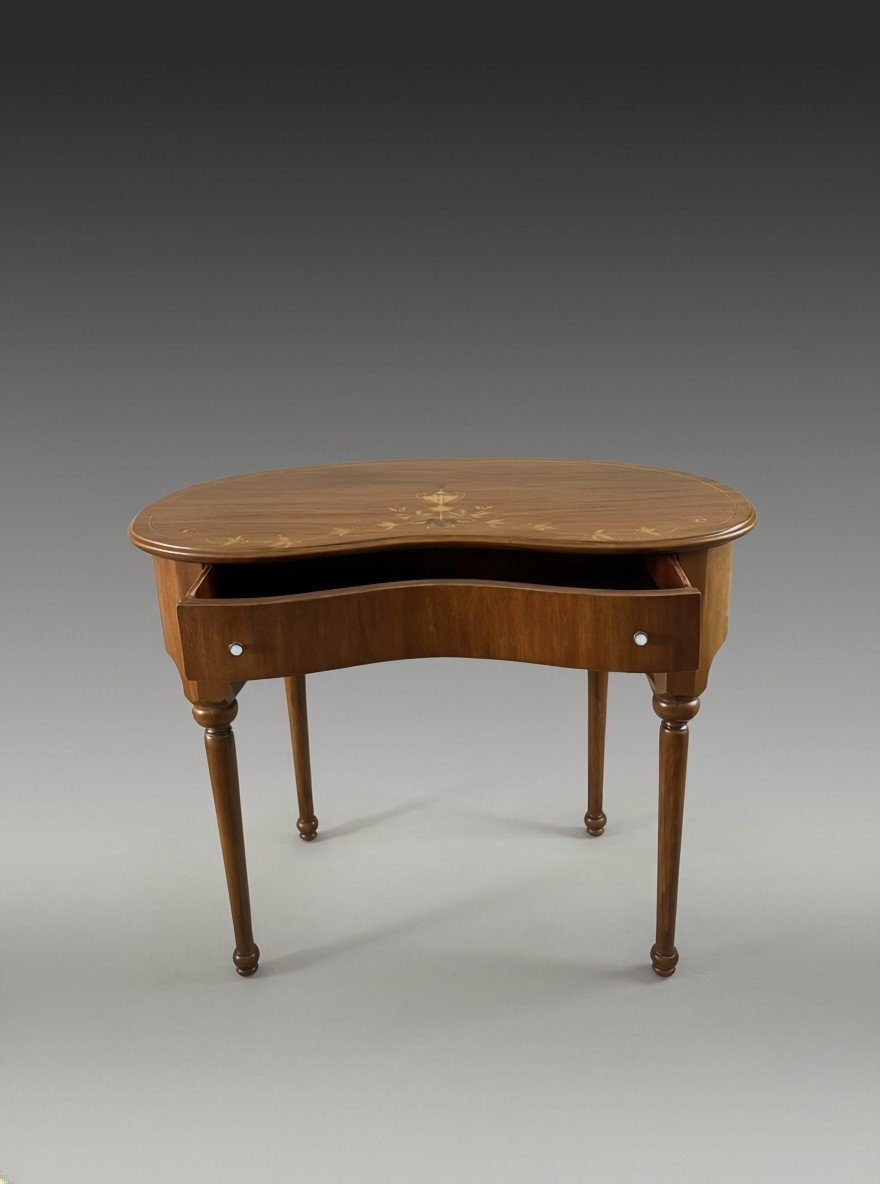 Kidney-shaped writing desk with the wide central drawer open, showing its curved front