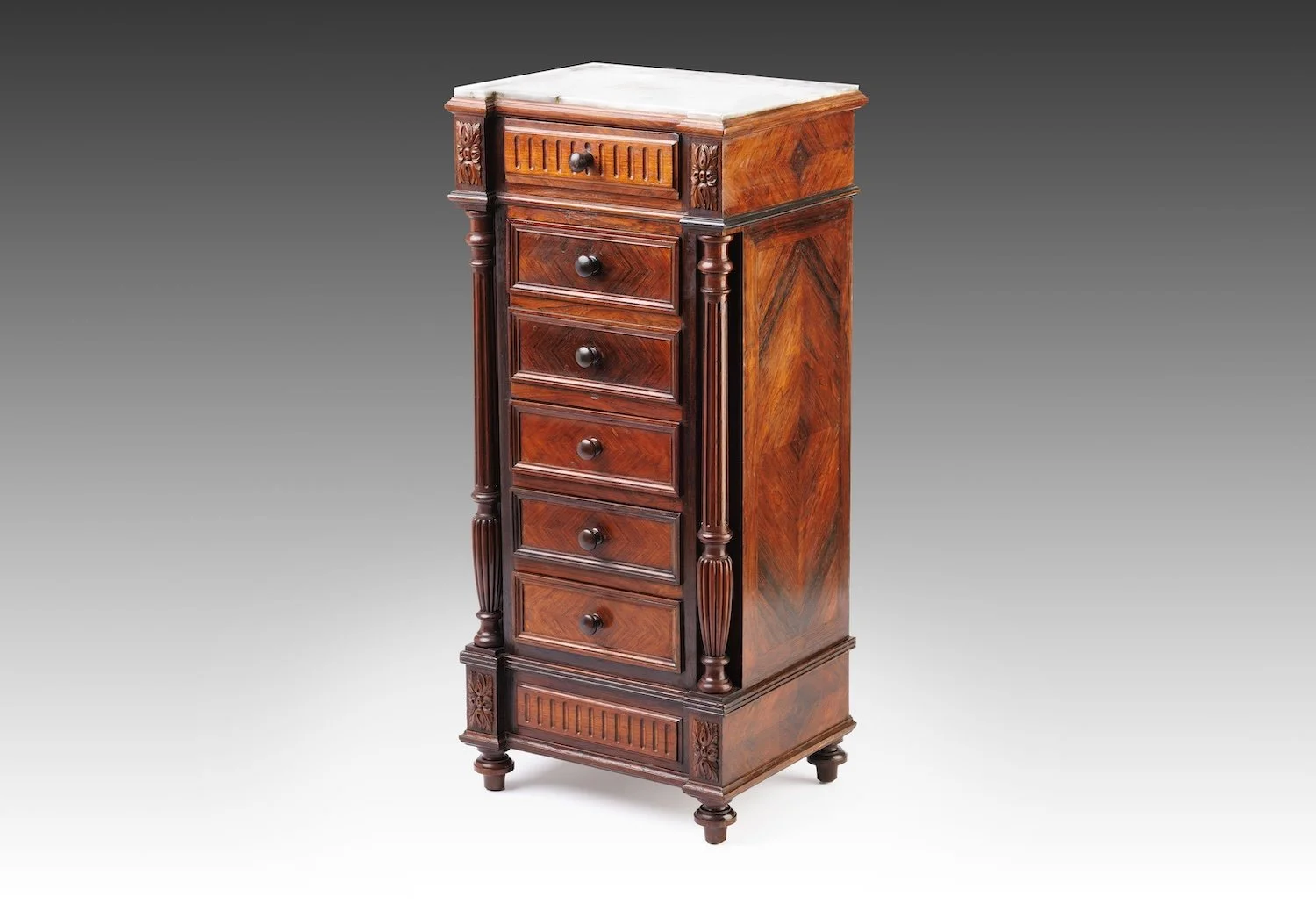 Antique Renaissance Revival bedside cabinet with a white marble top and figured veneers, flanked by fluted half-columns, three-quarter view.