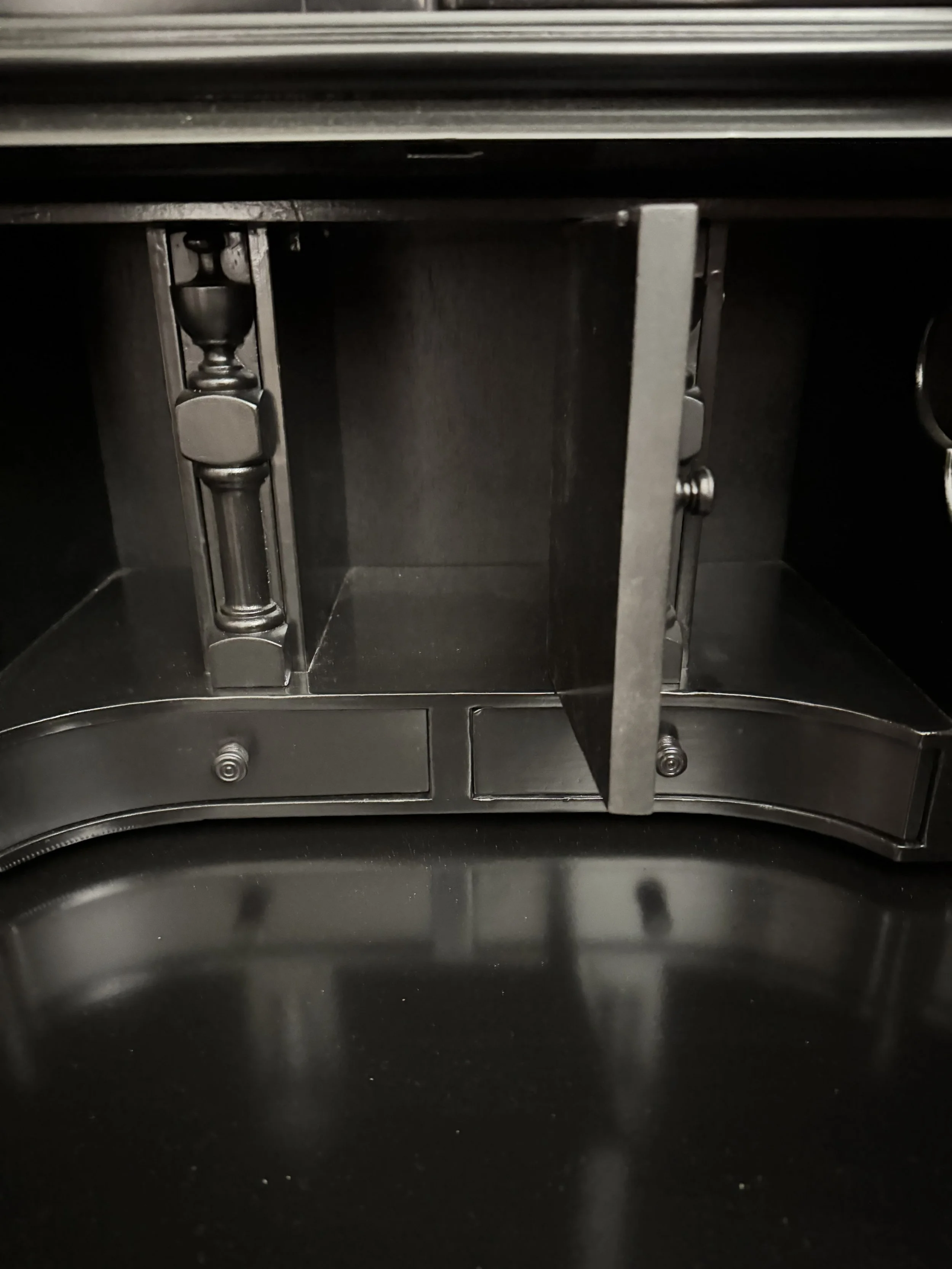 Fitted interior: pigeonholes, a central fan-carved prospect door flanked by turned columns, and four small drawers above the writing surface, all in black lacquer