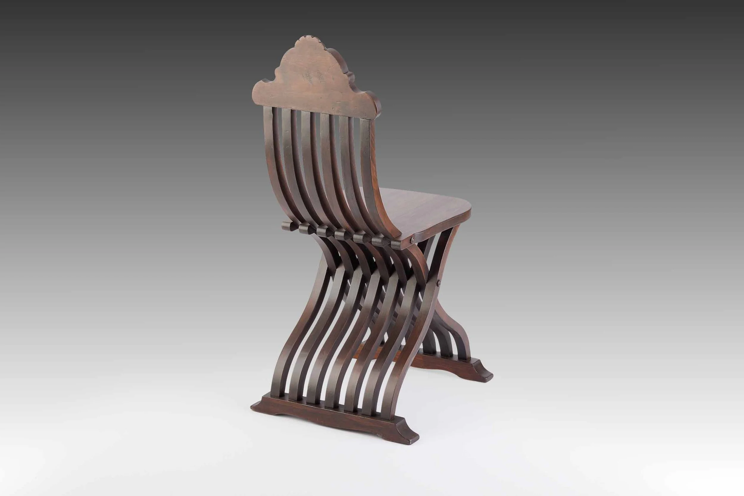 Matched pair of 19th-century Italian Renaissance Revival chairs in sculptural sedia tenaglia form with curved slats and carved backrests, restored by Acanthus Home