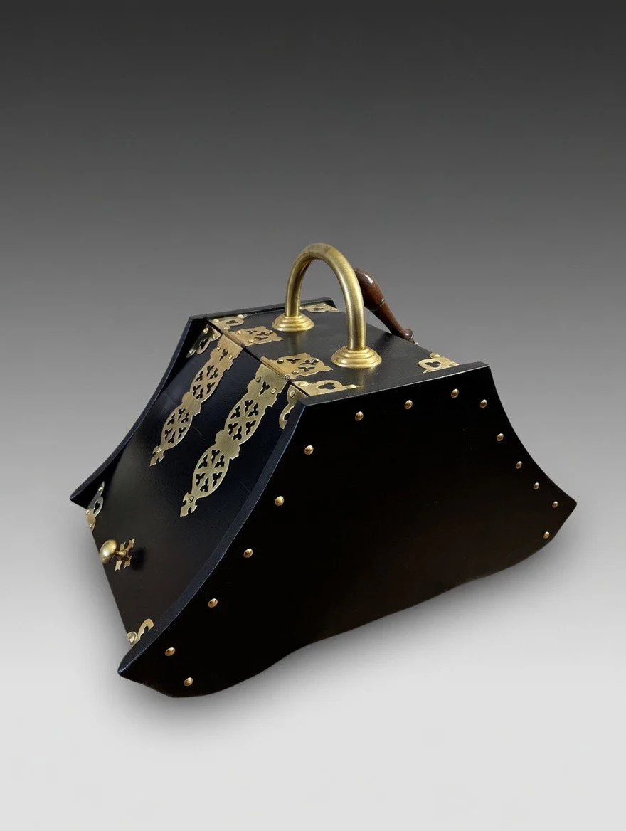 antique coal scuttle in black with brass hardware, angled three-quarter view
