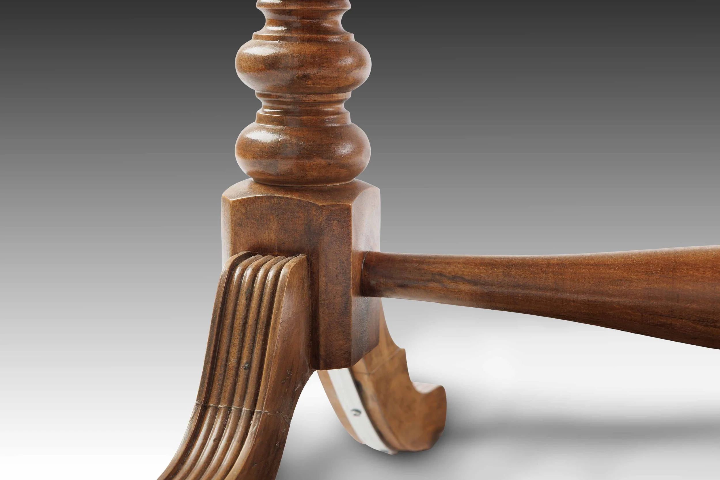 Close-up of a turned wooden leg on The Laureline Vanity Table, highlighting its sculpted profile, rich patina, and hand-carved joinery.