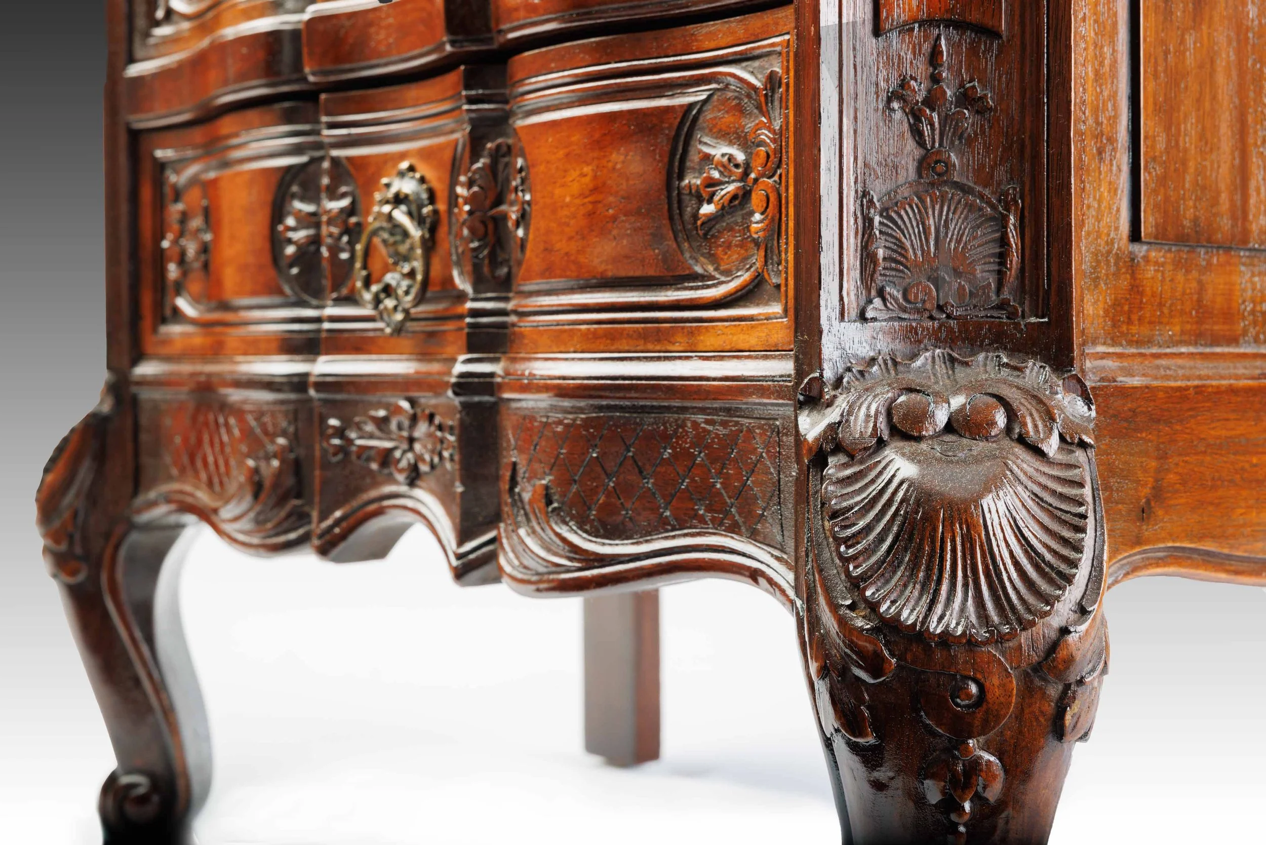 Close-up of The Roseroot's side panel, showing carved floral medallions and paneled woodwork with refined craftsmanship.
