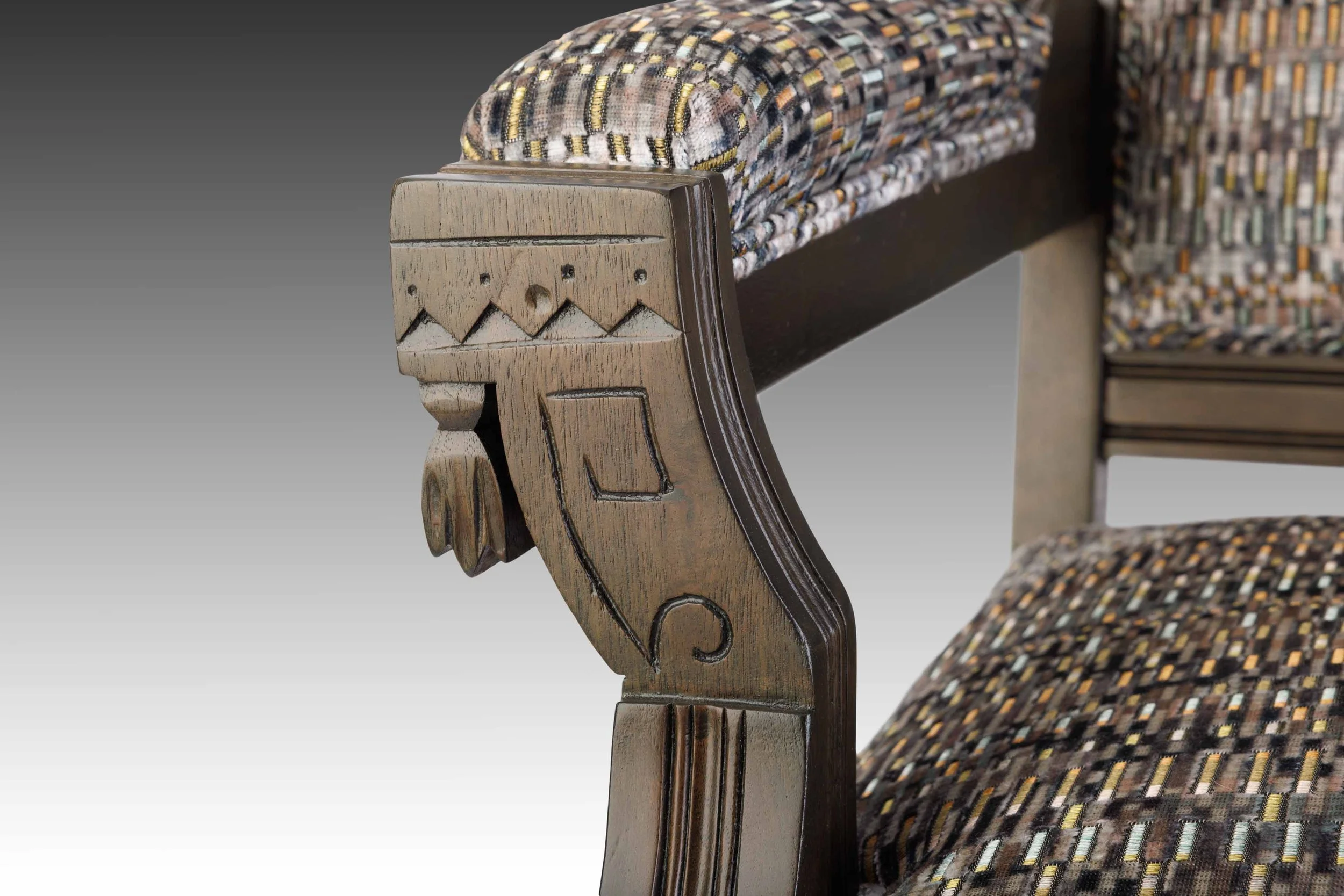 Left-arm facing settee with geometric carved details and colorful metallic jacquard upholstery.