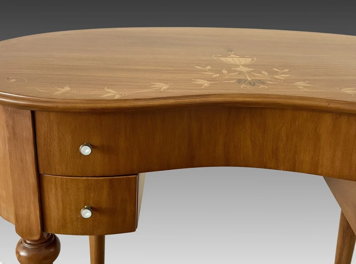 Kidney-shaped writing desk from the left, showing the marquetry top and slender turned legs