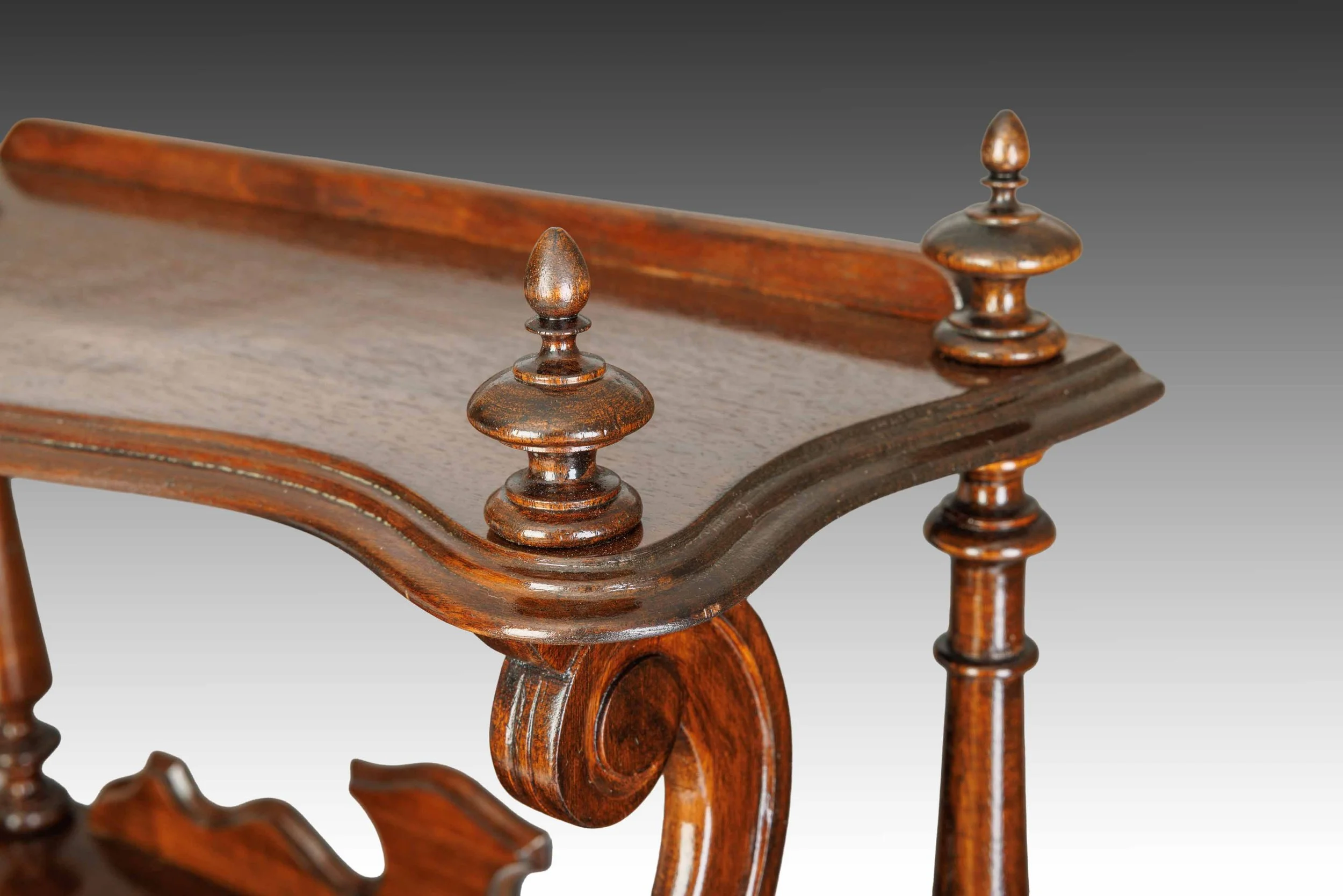 Detailed view of turned finials and serpentine edging on the top shelf of The Bracknell Whatnot.