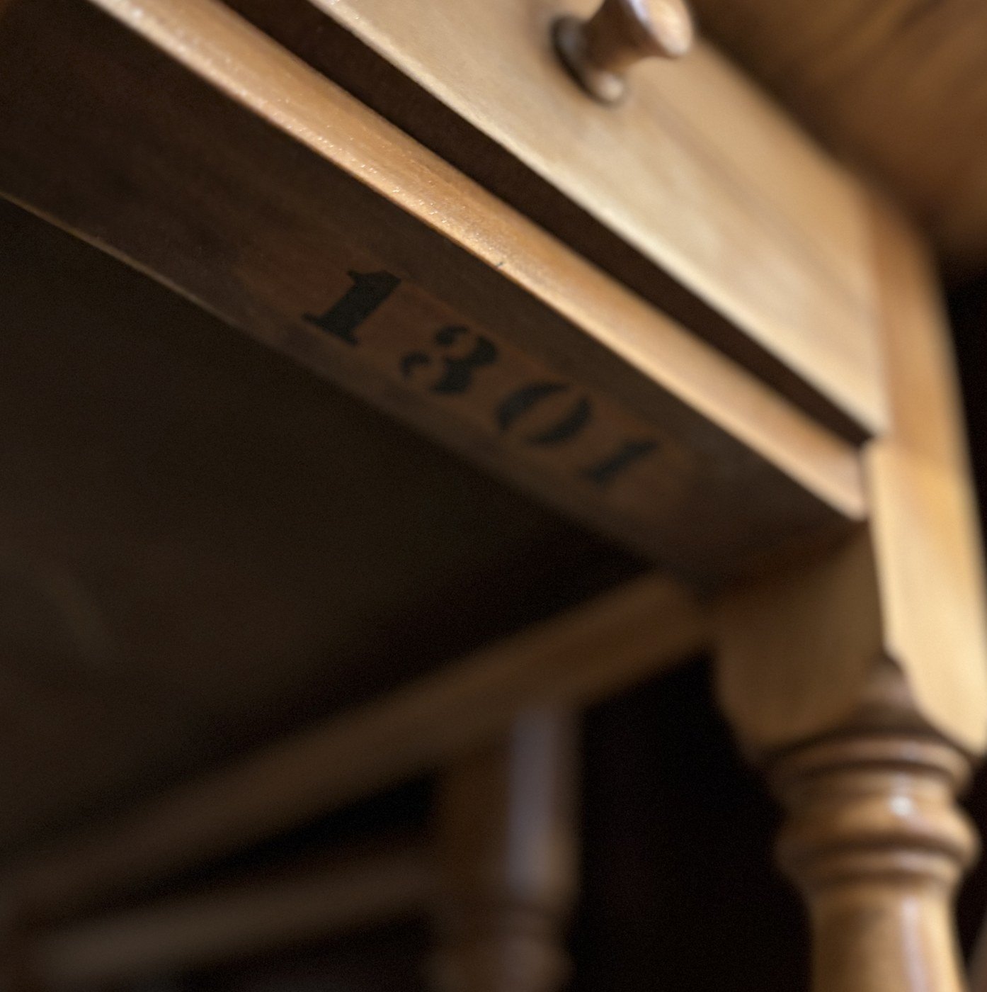 Stencilled factory number 1301 on the underside apron rail of a Grand Rapids gateleg table