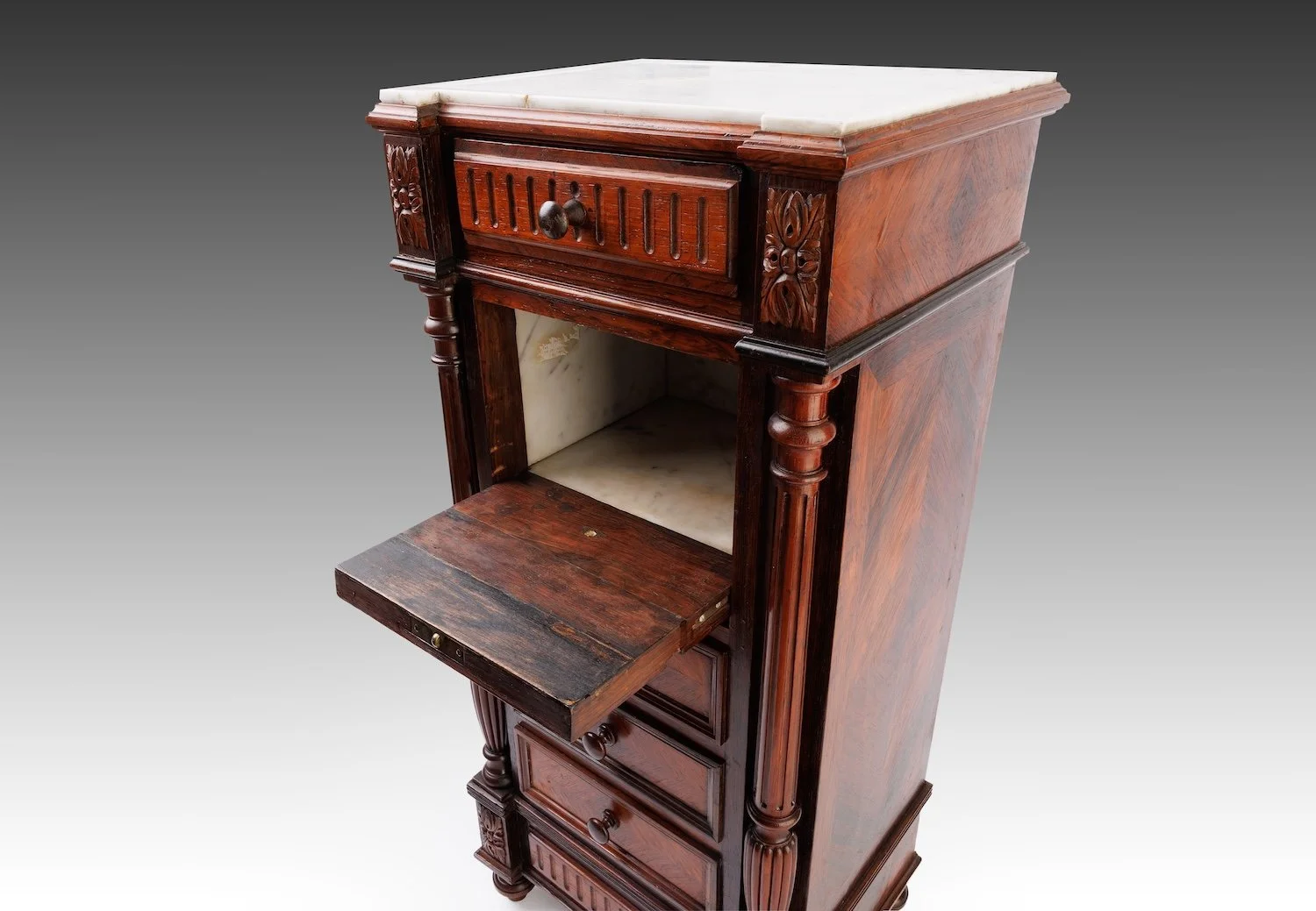 The fall-front lowered to reveal the white marble-lined interior chamber, faced on the outside as two false drawer fronts.