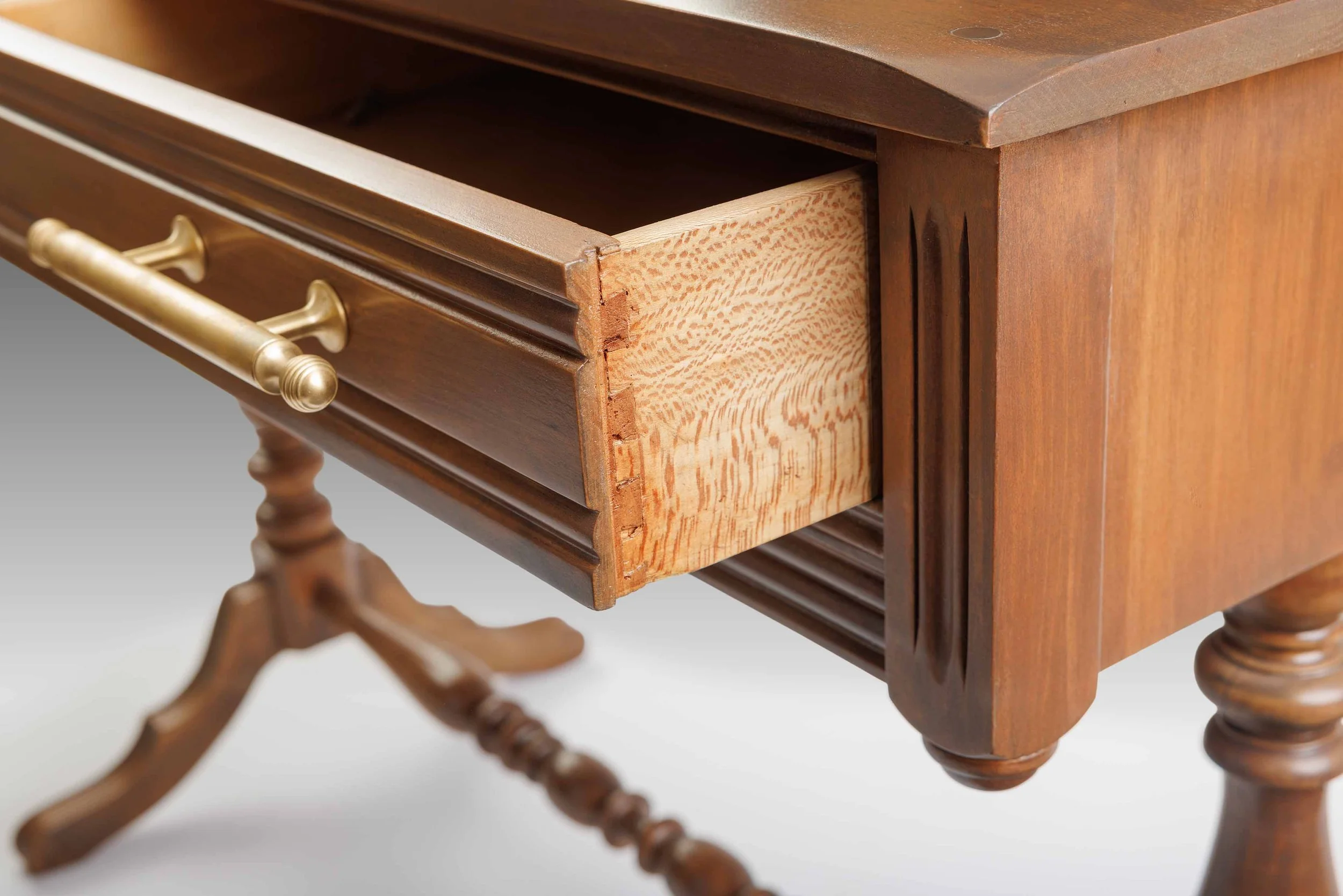 Open drawer view of The Laureline Vanity Table showcasing traditional dovetail joinery and the natural grain of the interior woodwork.