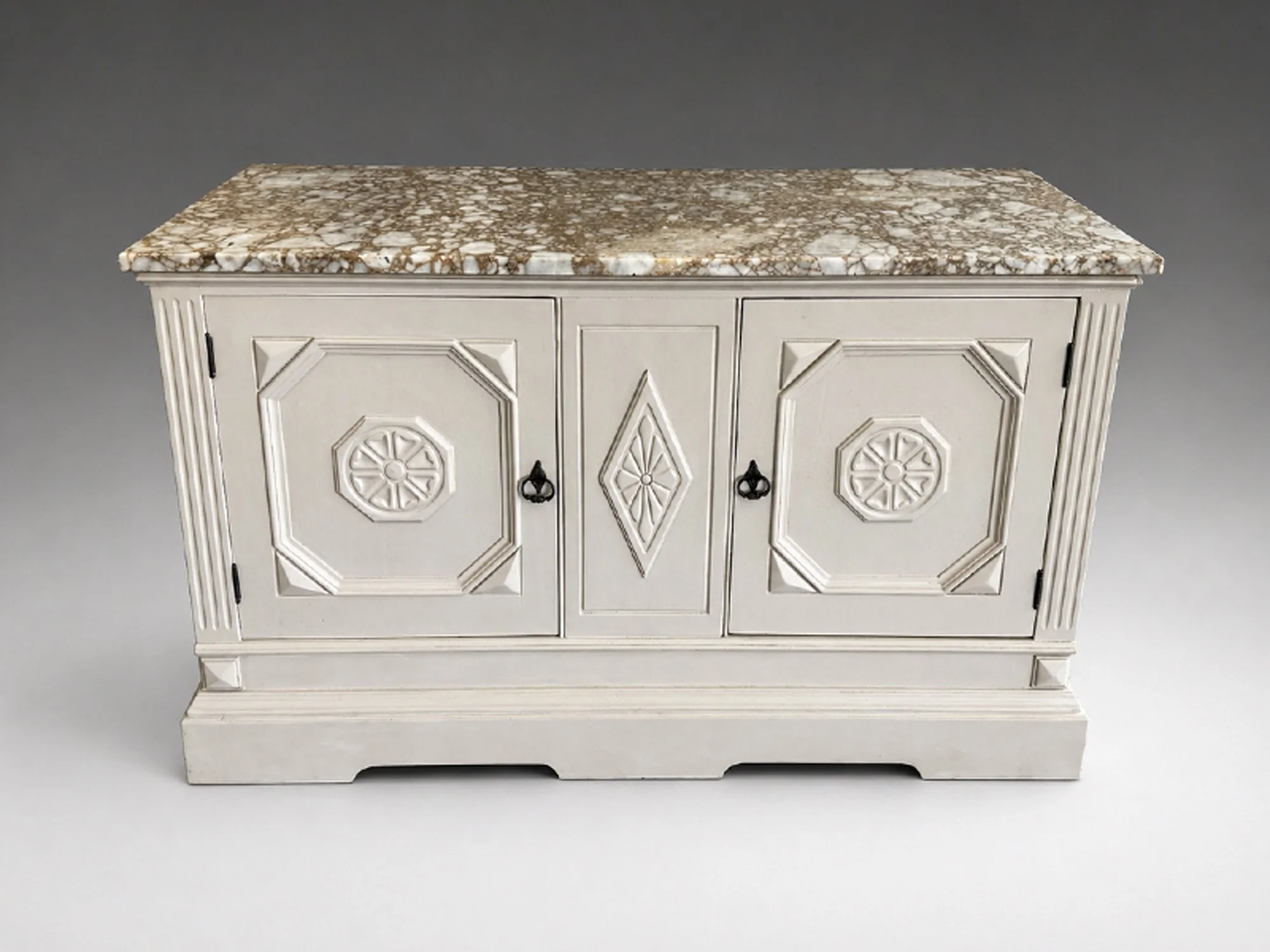 Painted antique cabinet with carved geometric panels, stone top, and dark hardware, front view, early twentieth-century European revival form