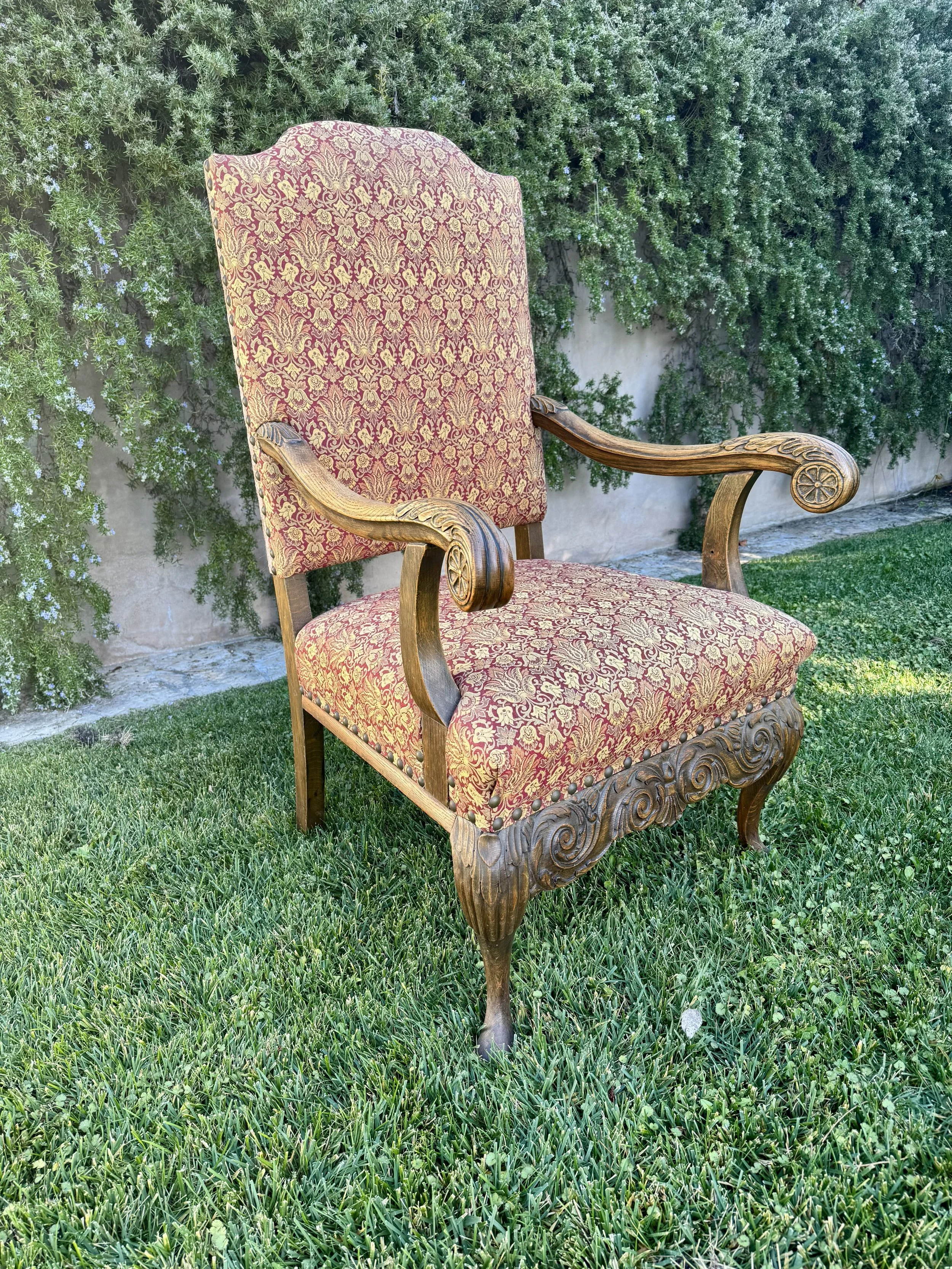 Antique oak armchairs prior to restoration, showing original patterned upholstery, softened surface condition, and misalignment between textile and frame.